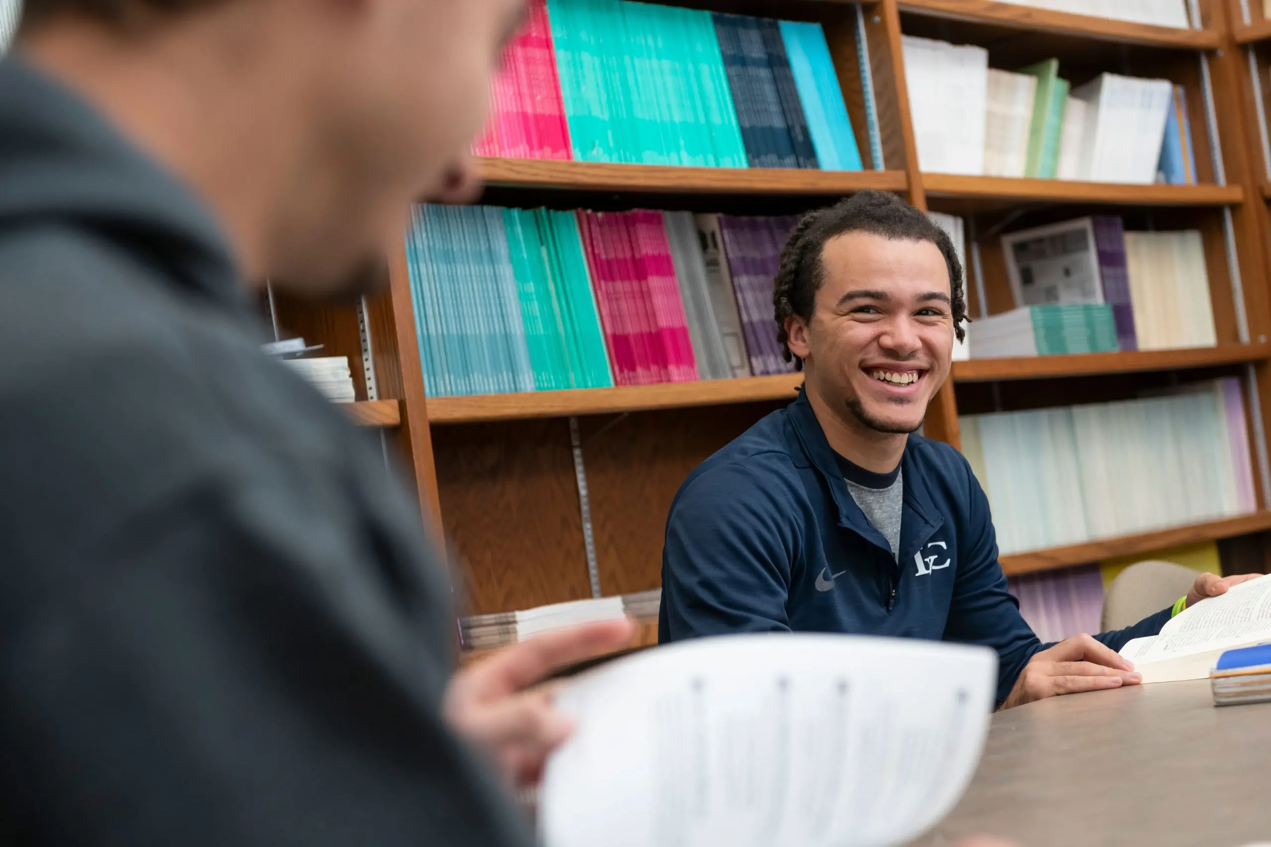 Smiling student in library.
