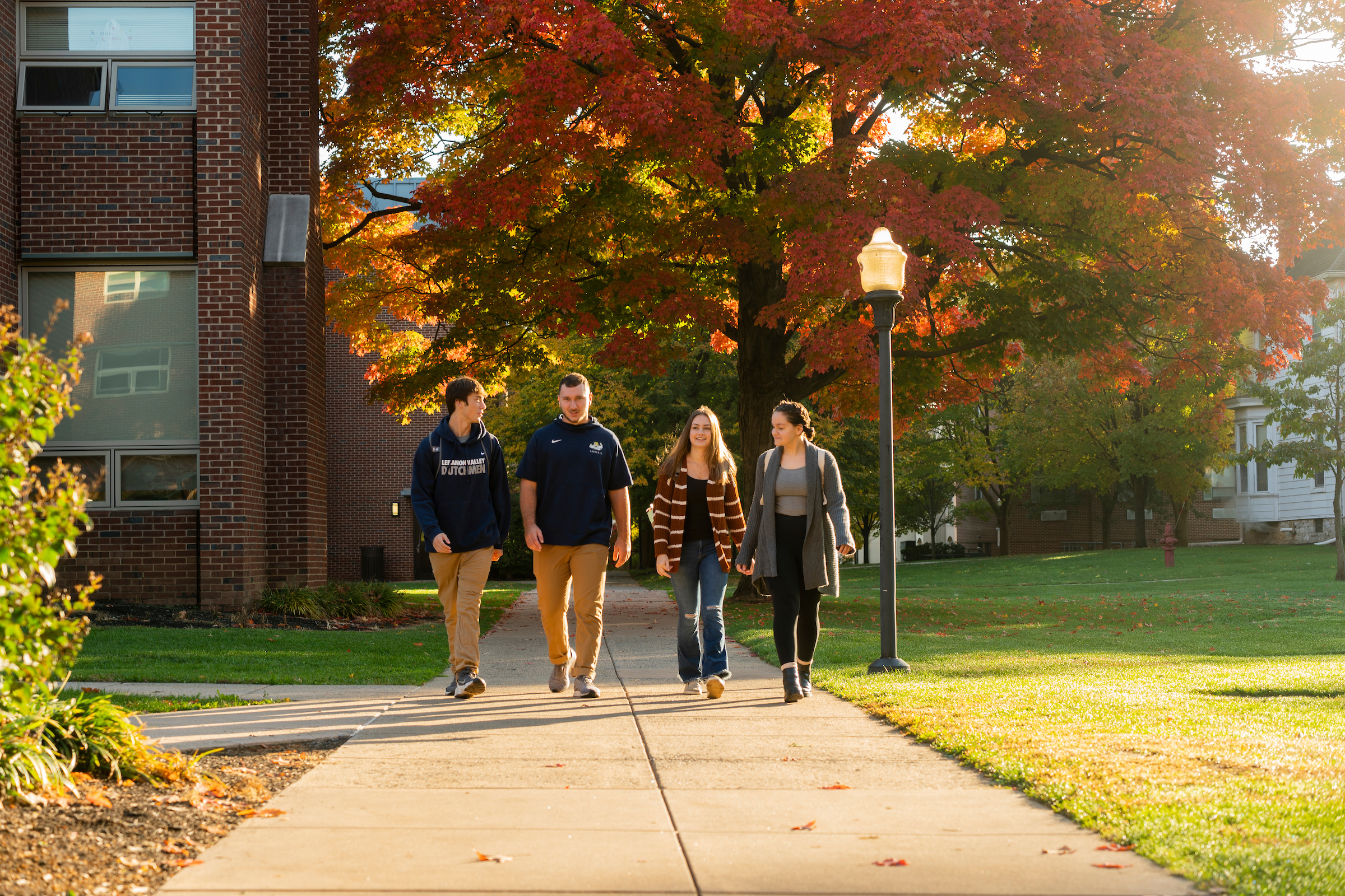 students walk on campus in fall