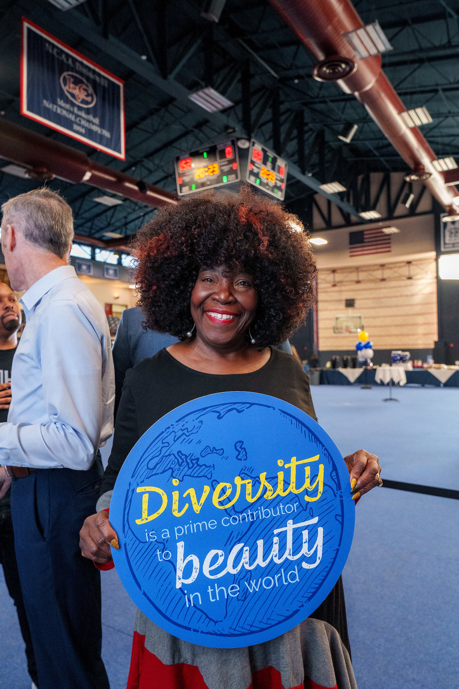 Dr. Felicia Brown-Haywood holds diversity sign during accepted student event