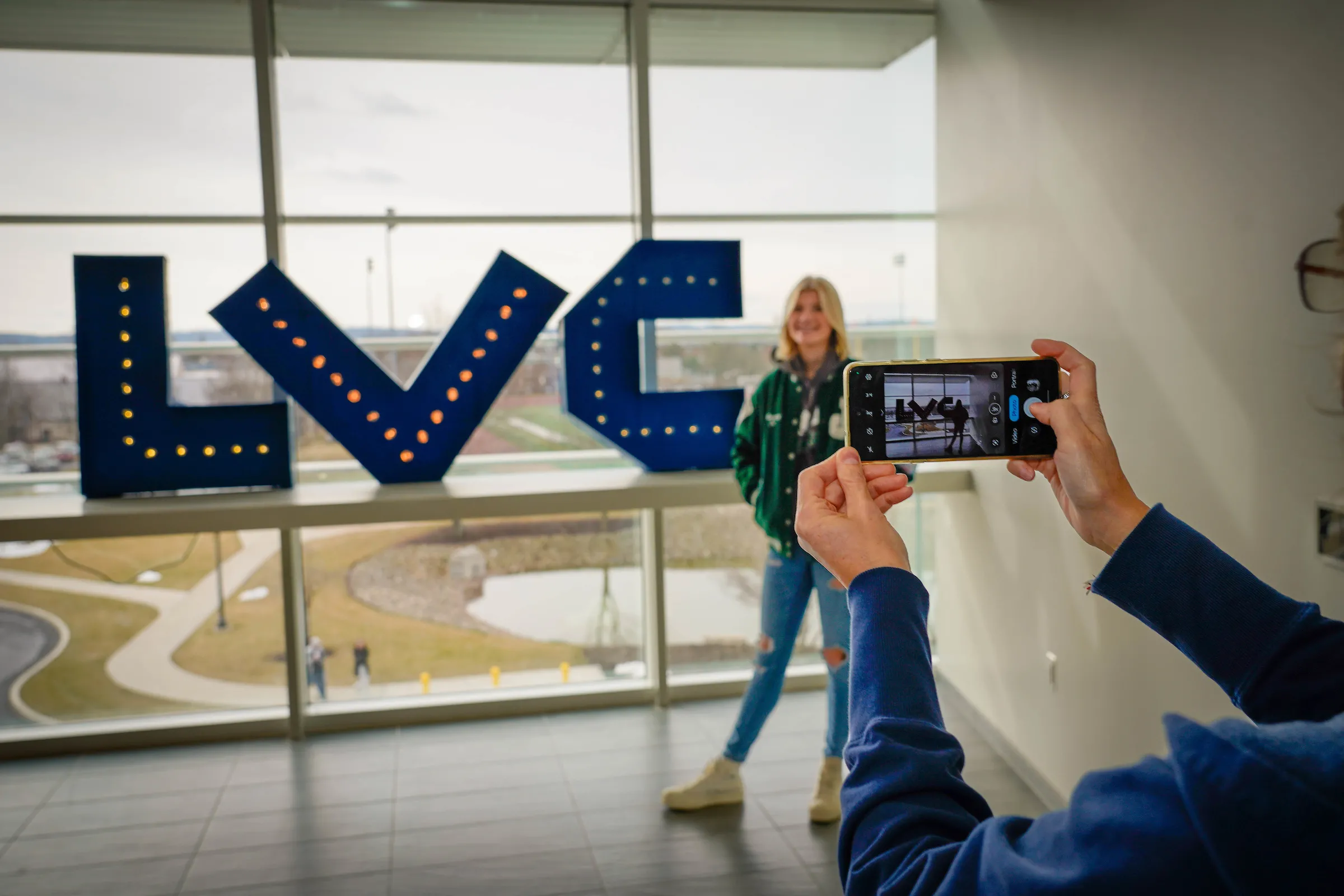 Student poses for photo with LVC letters at LVC Live admitted student event