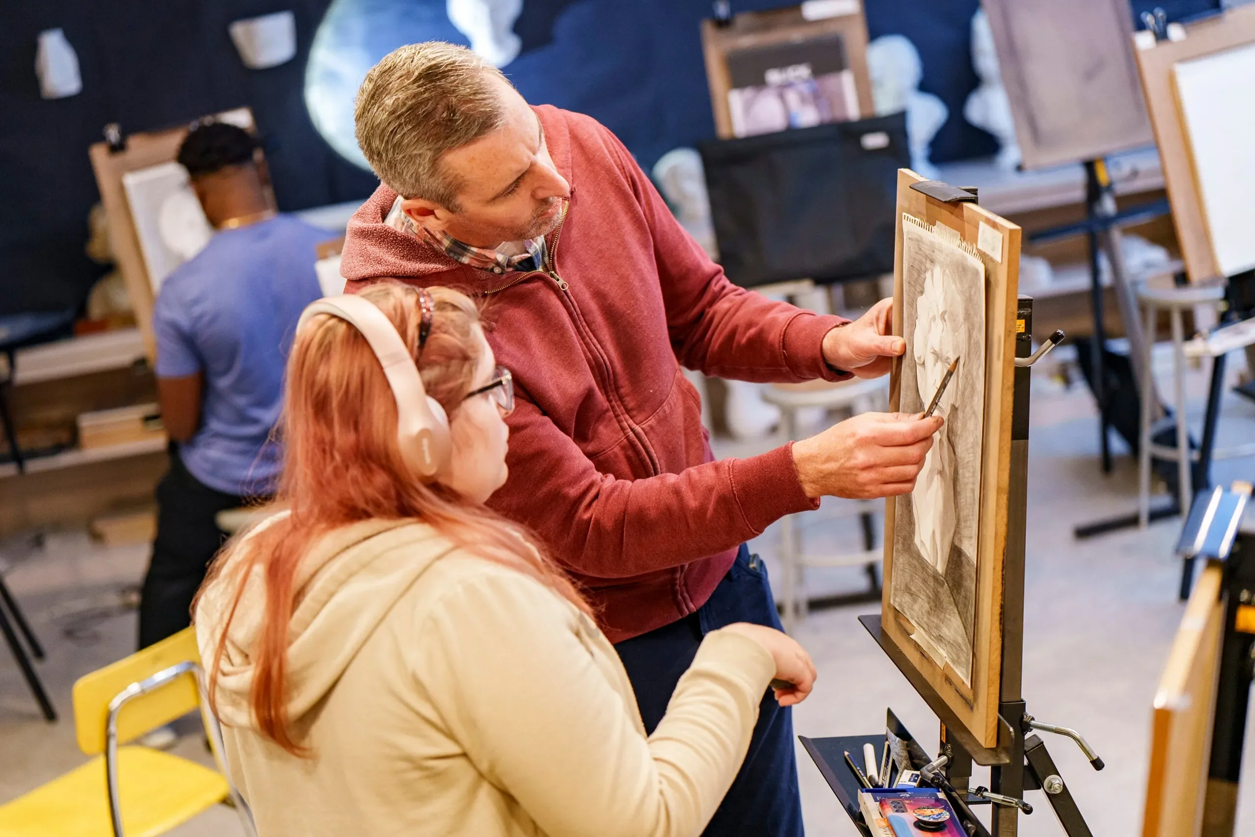 Dr. Grant Taylor works with student during drawing class