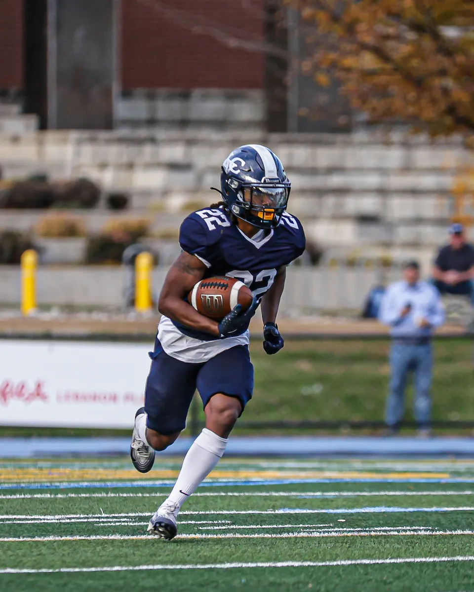 LVC football player runs on field with ball