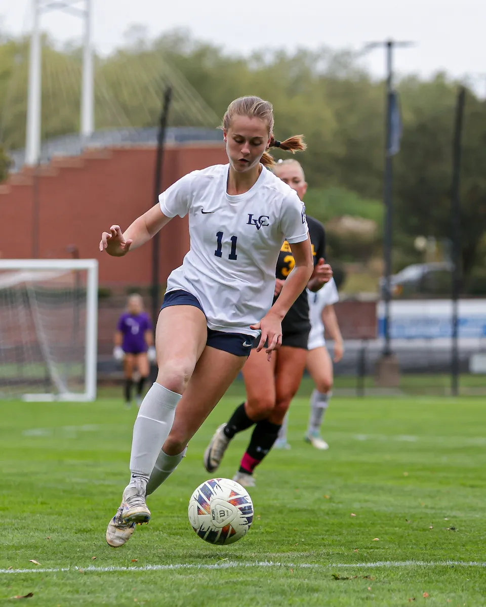 LVC women's soccer player dribbles ball on field