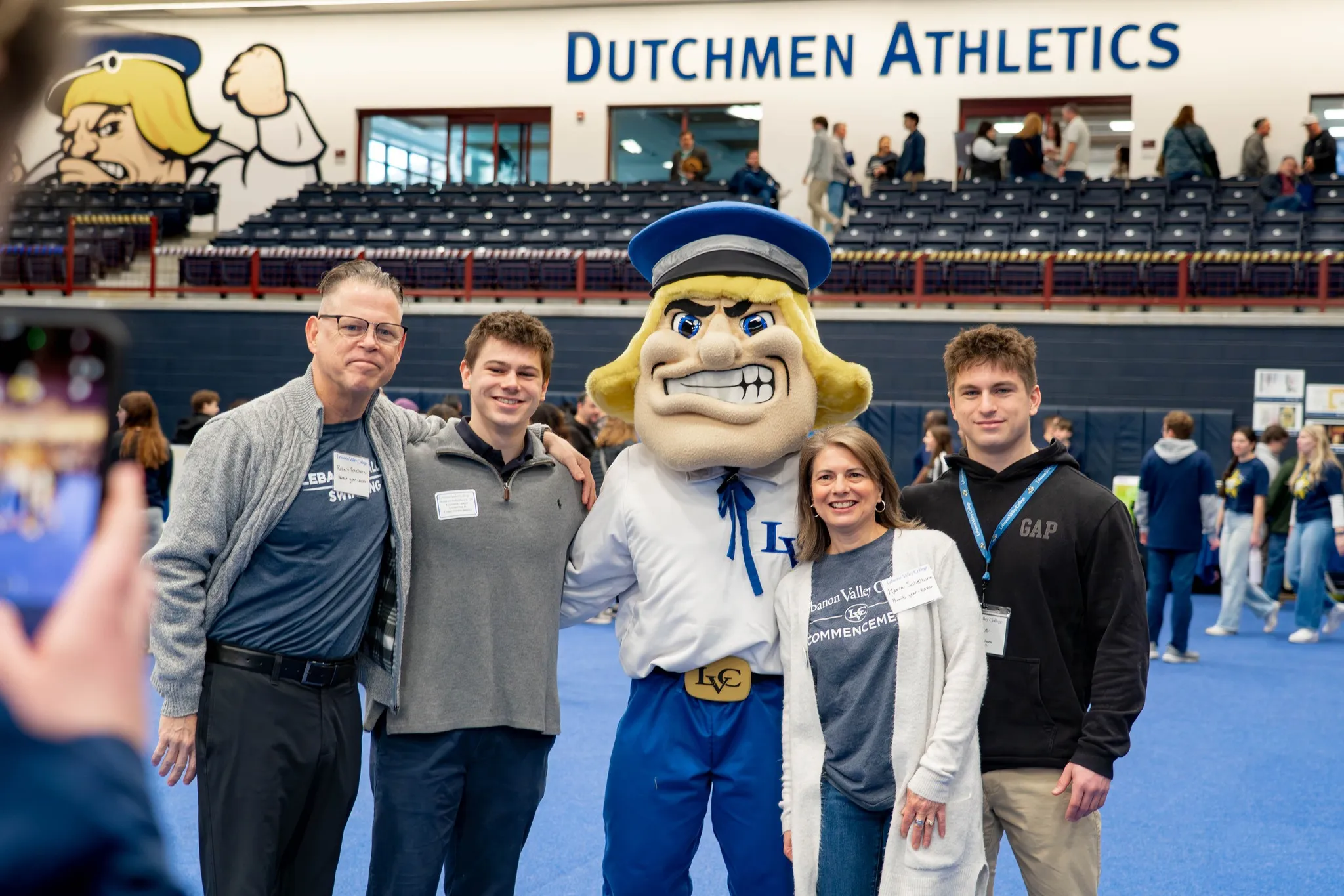 Family poses with Dutchman mascot at campus event