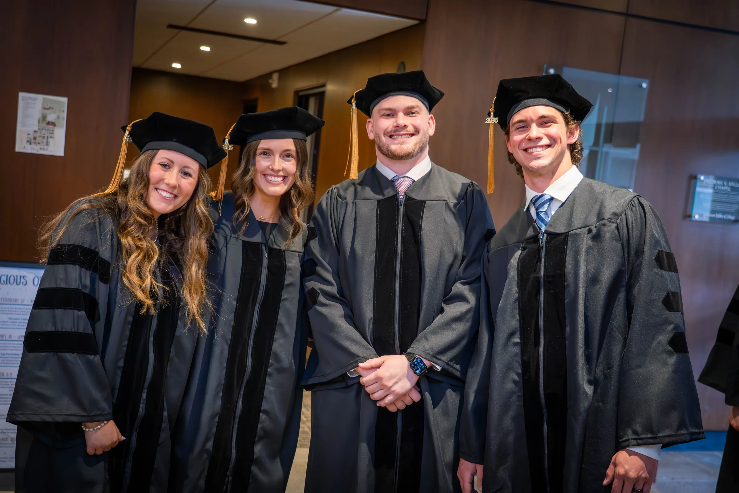 Doctor of Physical Therapy graduates smile at hooding ceremony