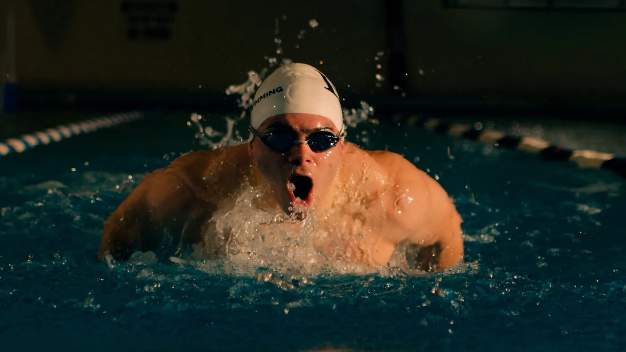 LVC student athlete swims in pool lane