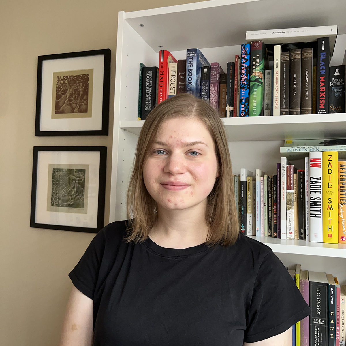 Rachael Speck in front of a bookcase