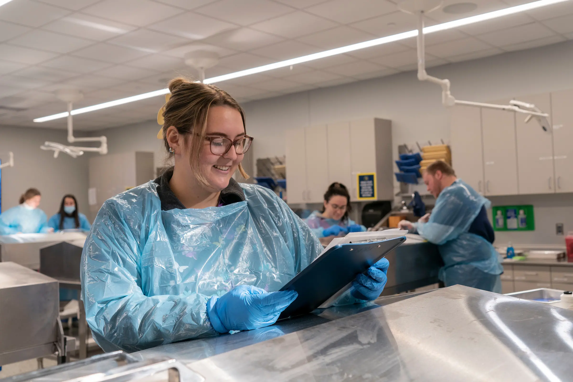 Student looks at paperwork in cadaver lab