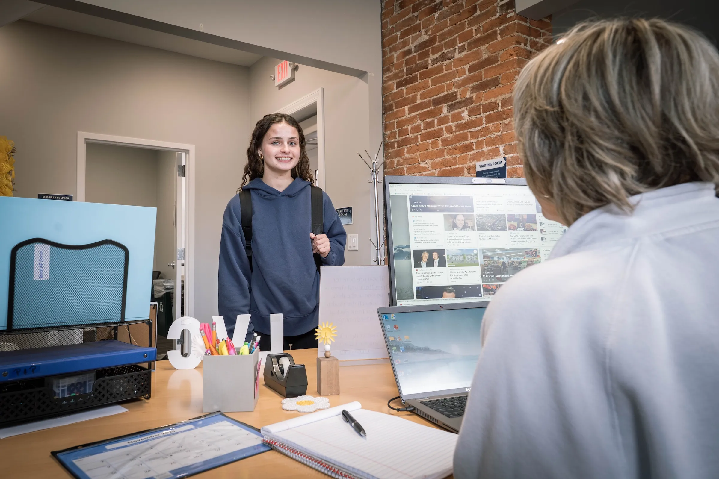 Student stands at Counseling Services welcome desk