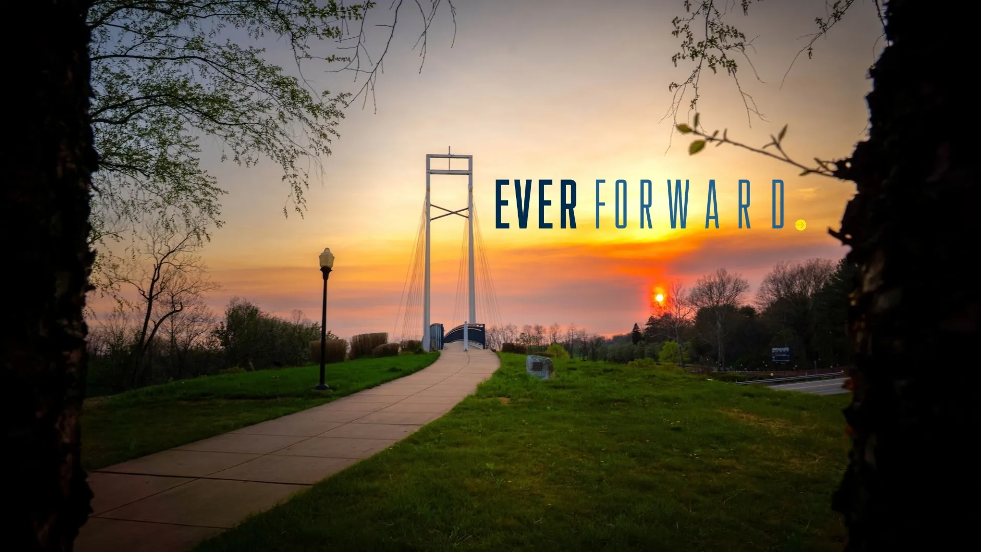 LVC bridge at sunset with Ever Forward campaign logo
