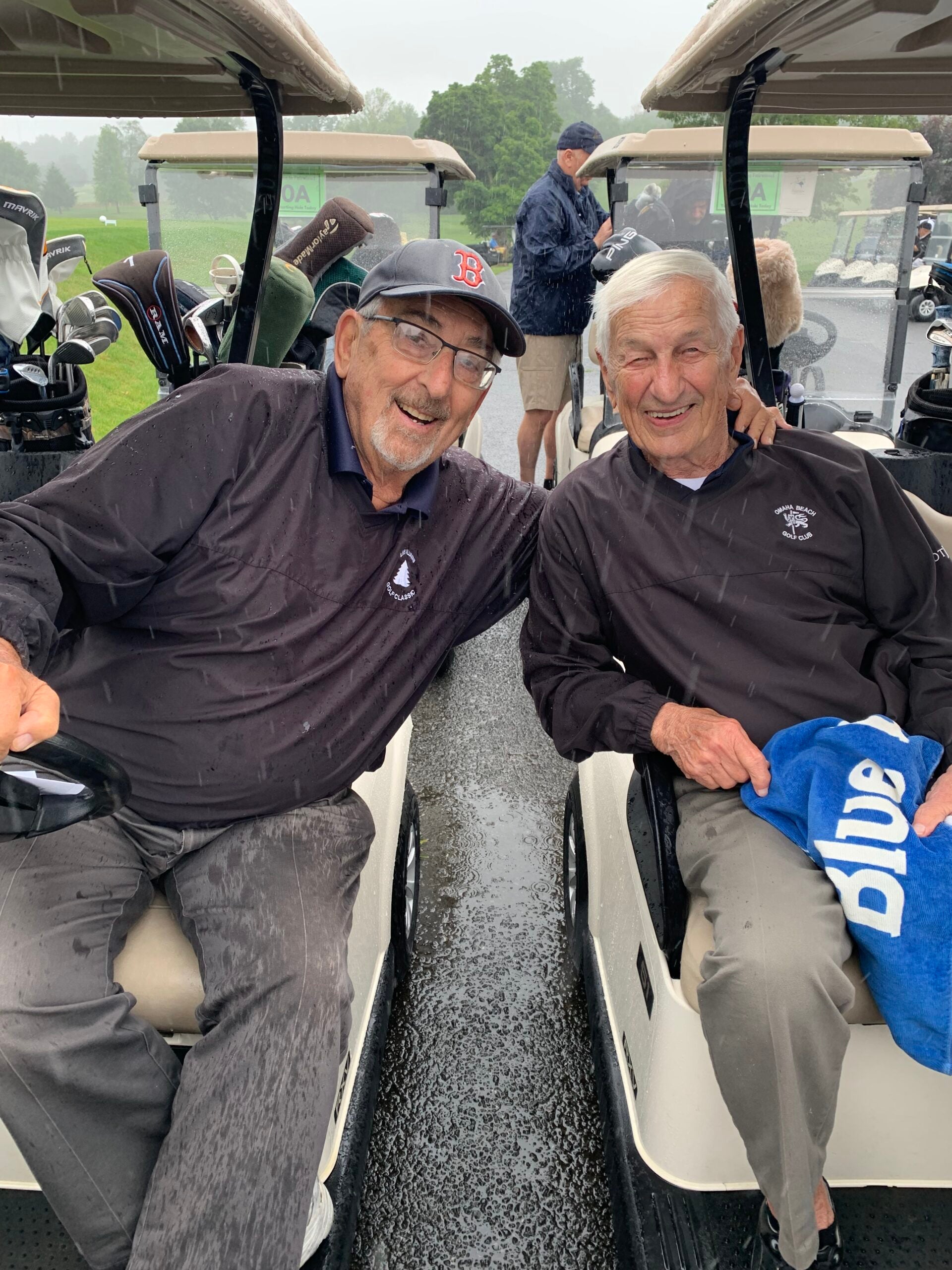 LVEP golf tournament participants sit in golf carts in the rain