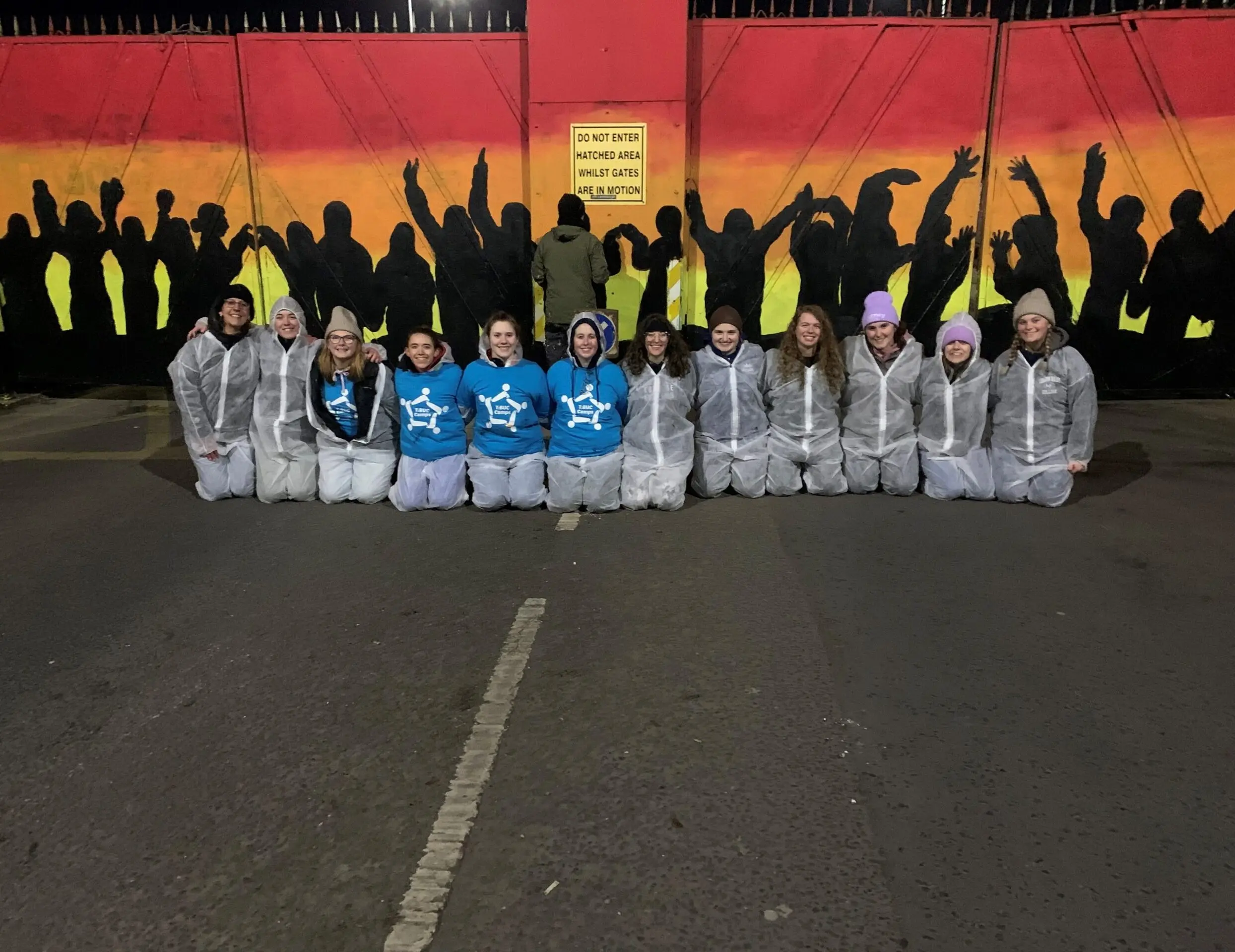 LVC students pose in front of mural during service trip in Northern Ireland.