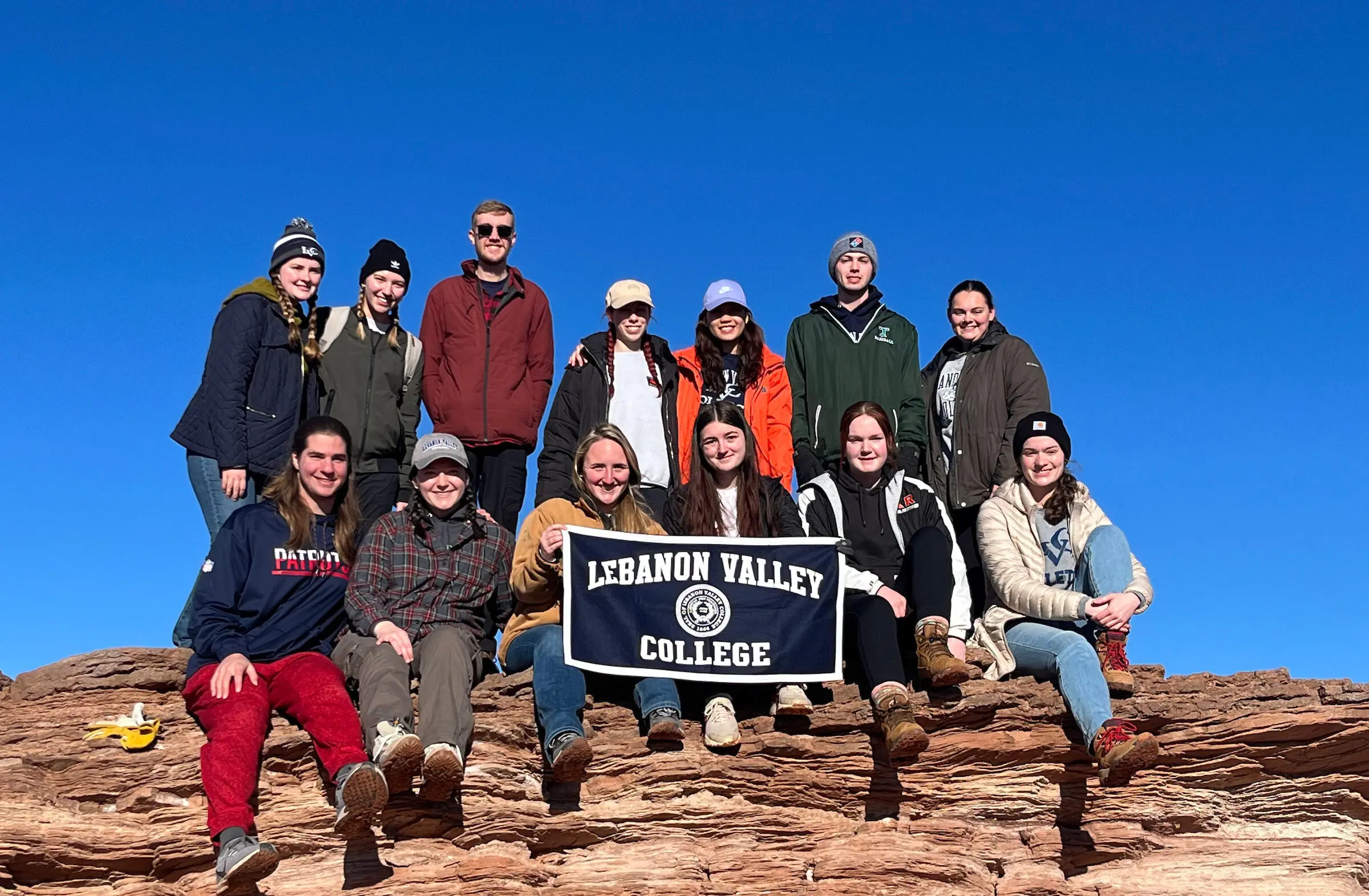 Students pose with LVC banner during community service trip to Arizona