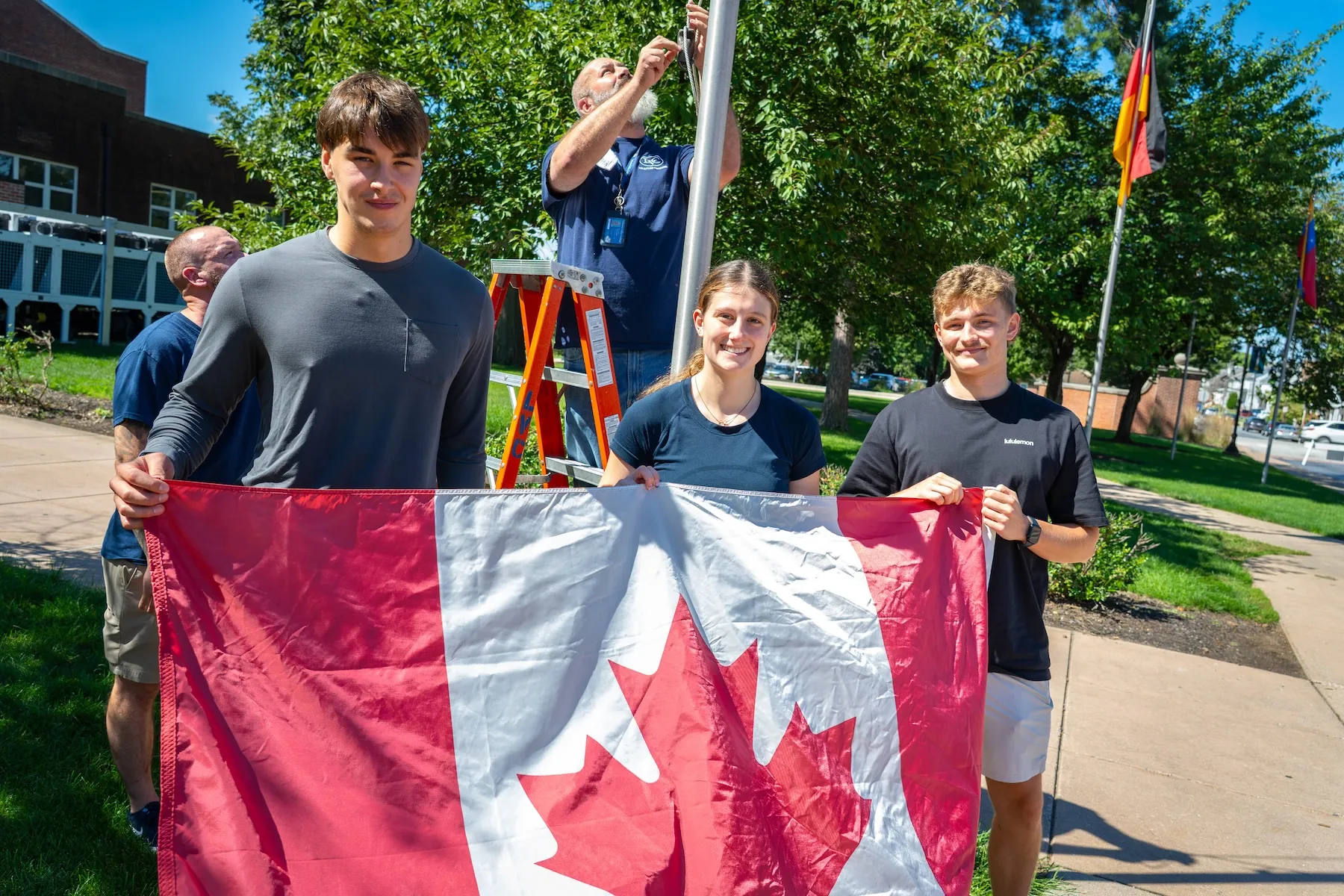 New LVC international students pose with Canadian flag at flag raising ceremony