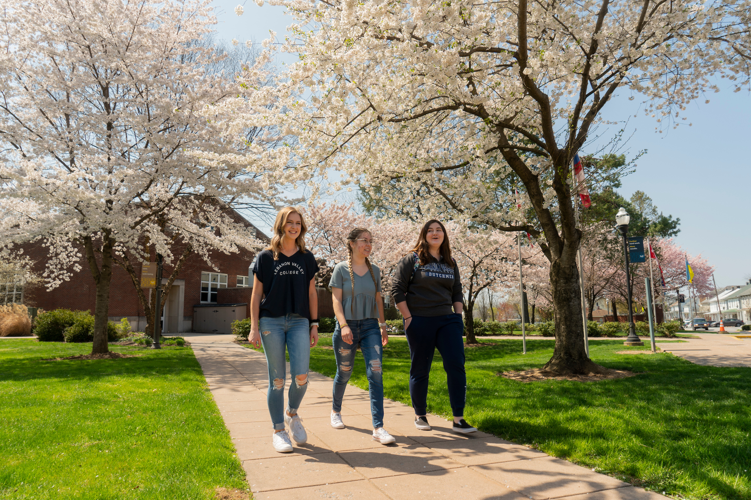 Students walk on campus in the spring