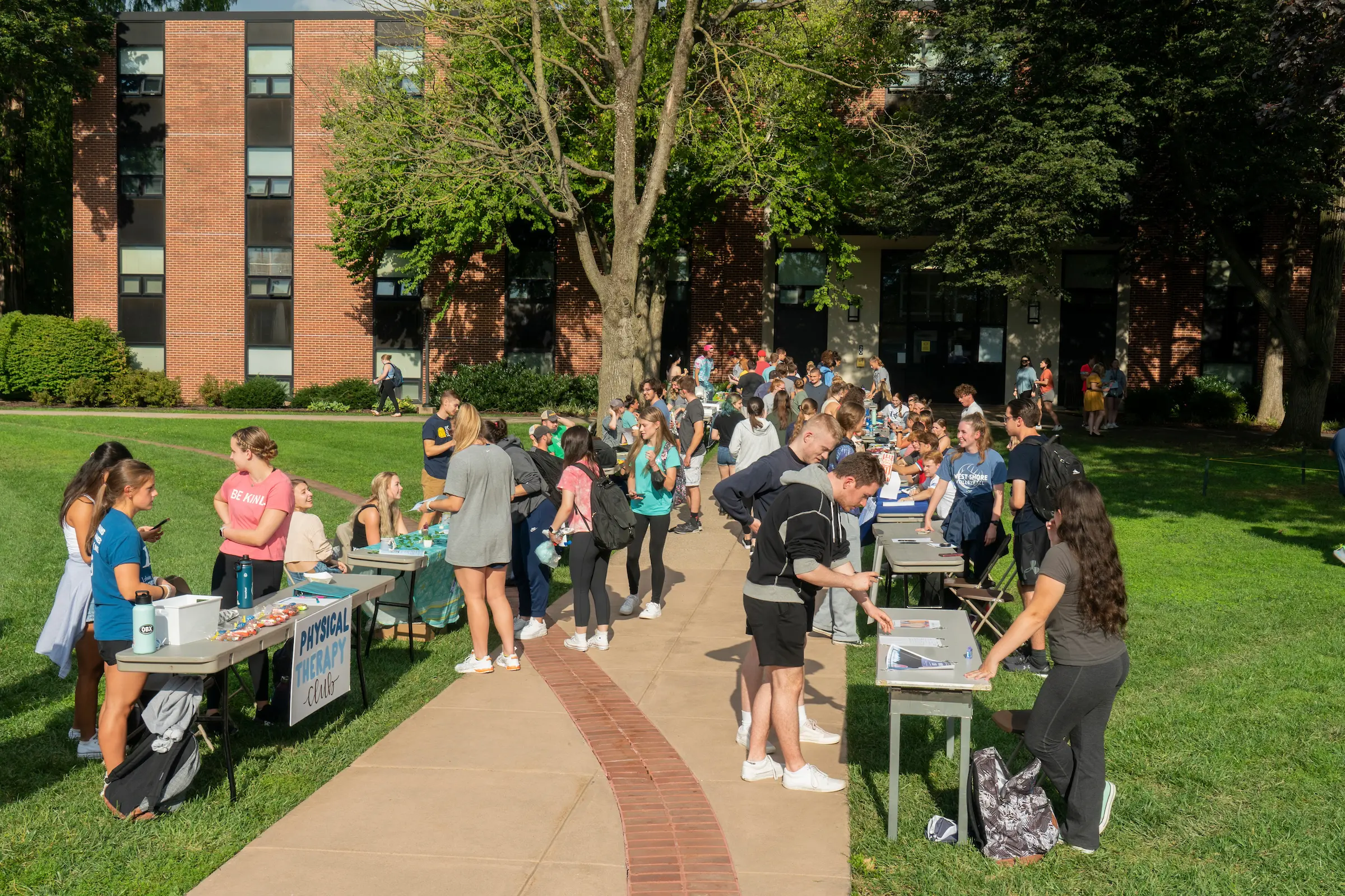 Students visit tables at engagement fair