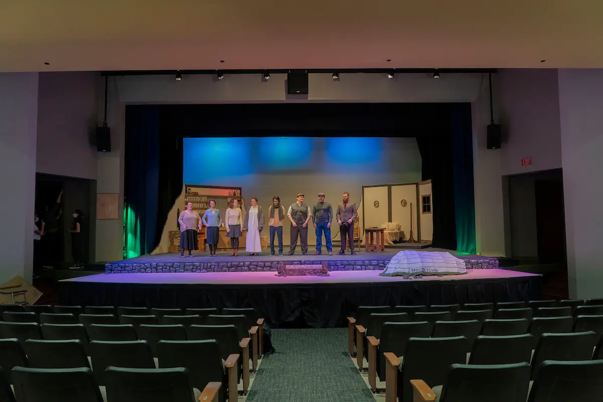 Students stand on stage at Leedy Theater