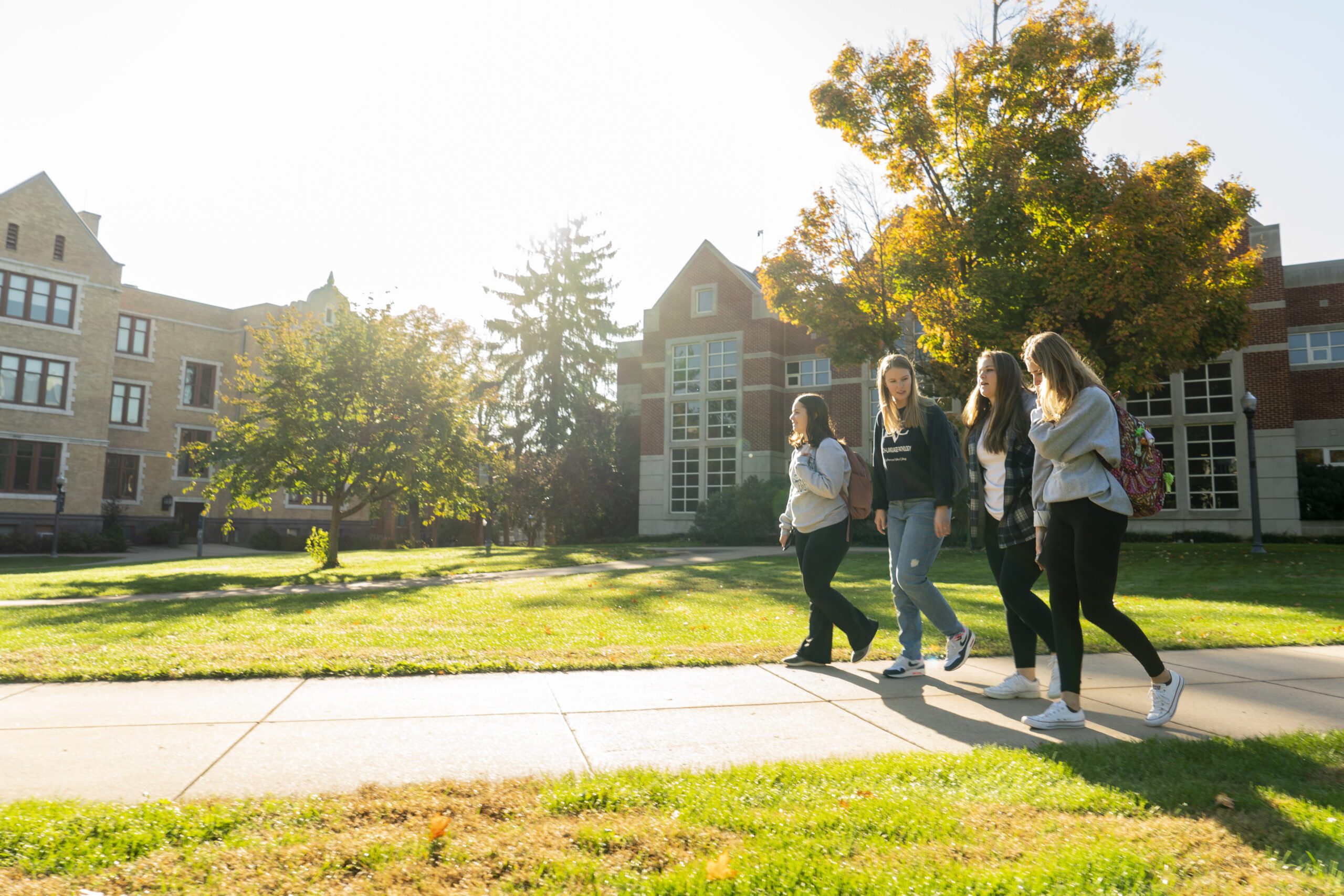 Students walk on campus on fall day