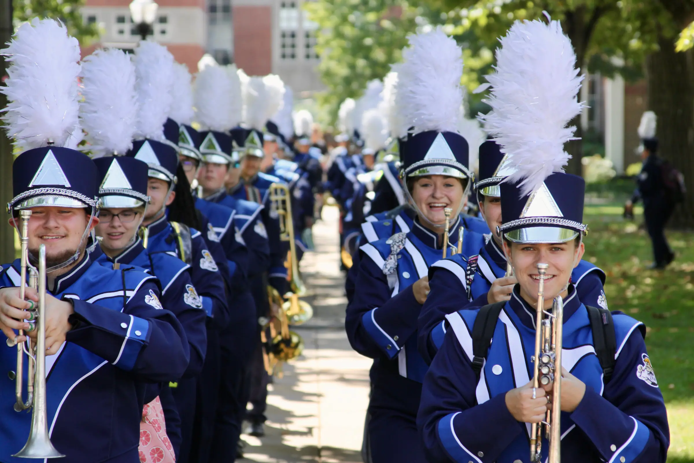 Marching band members smile