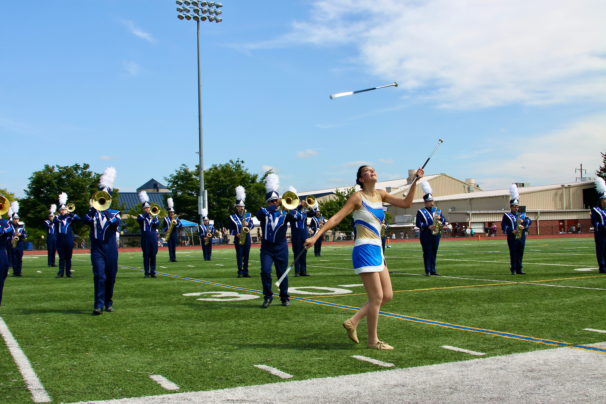 Baton twirler in front of marching band