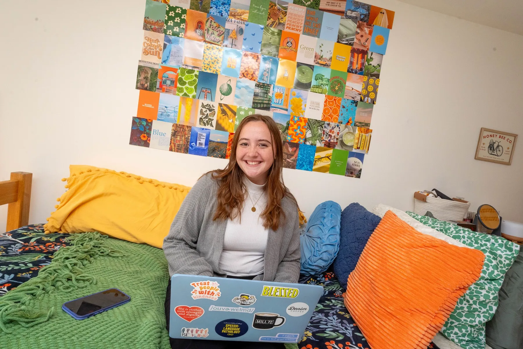 Student sits on bed in dorm room in Marquette Hall