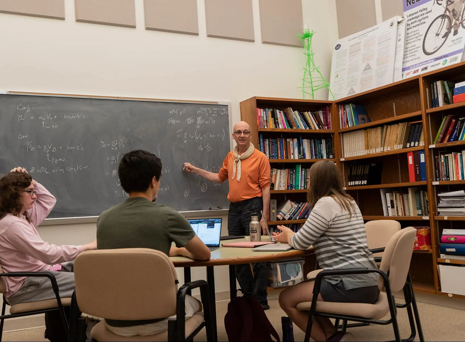 Professor teaching a small group of math students.