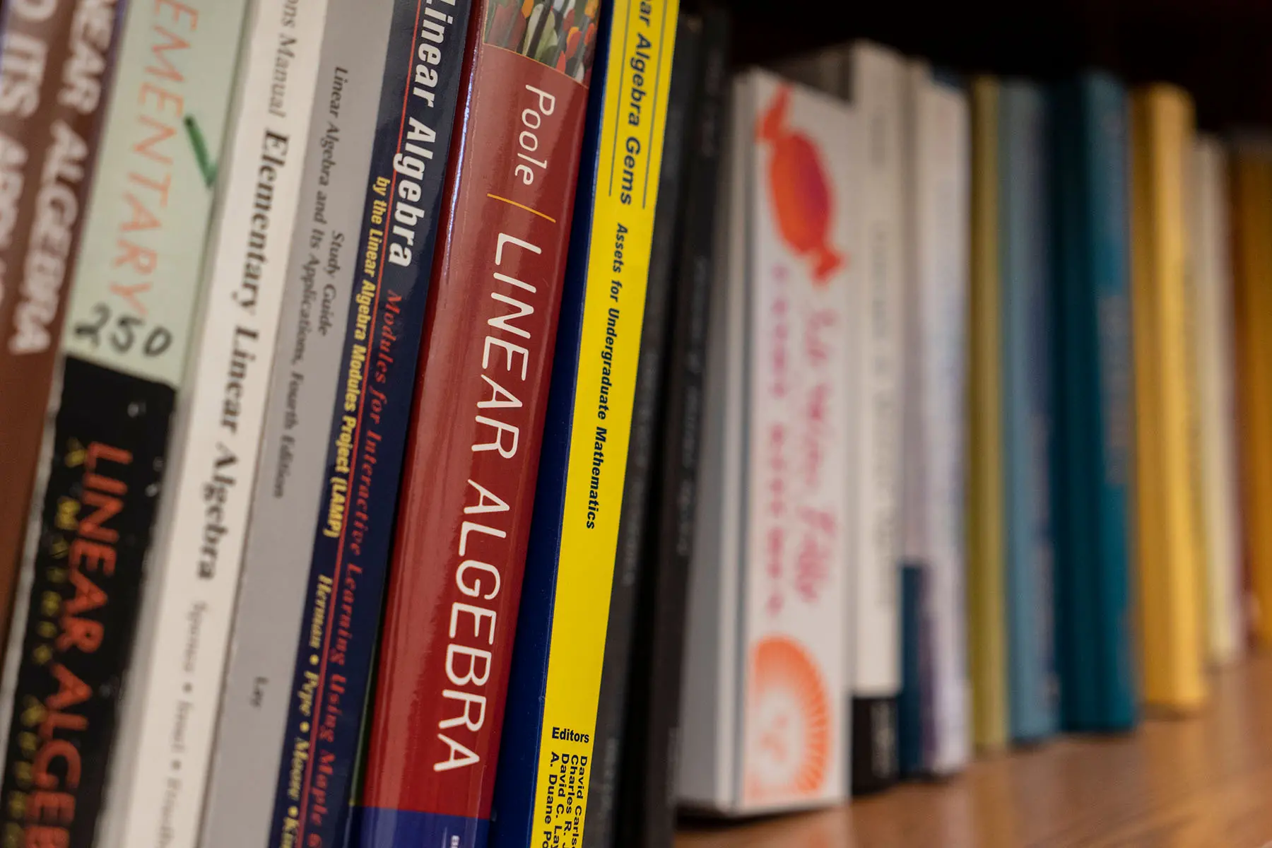 Math textbooks on a bookshelf.