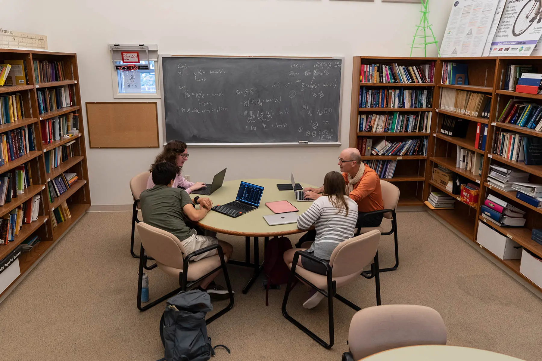 David Lyons sits around table with math students