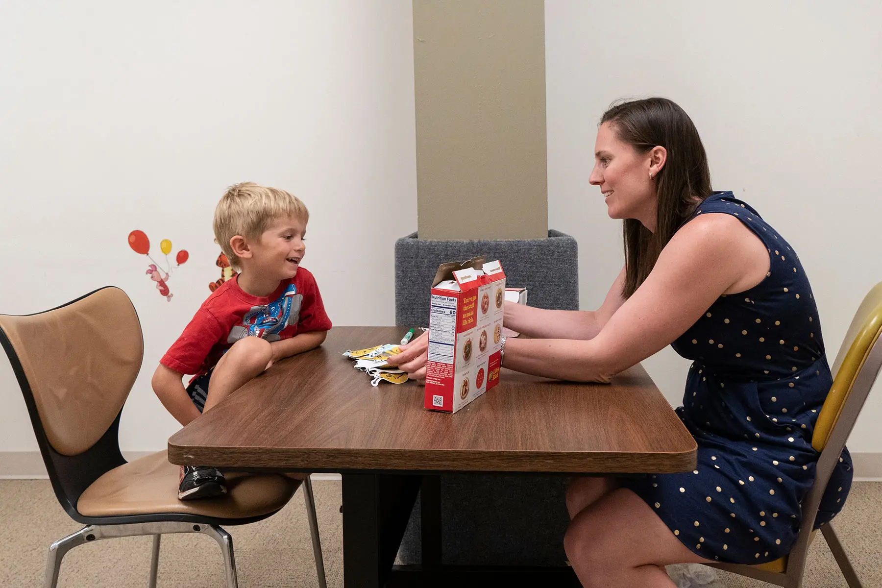 Psych student working with a child.