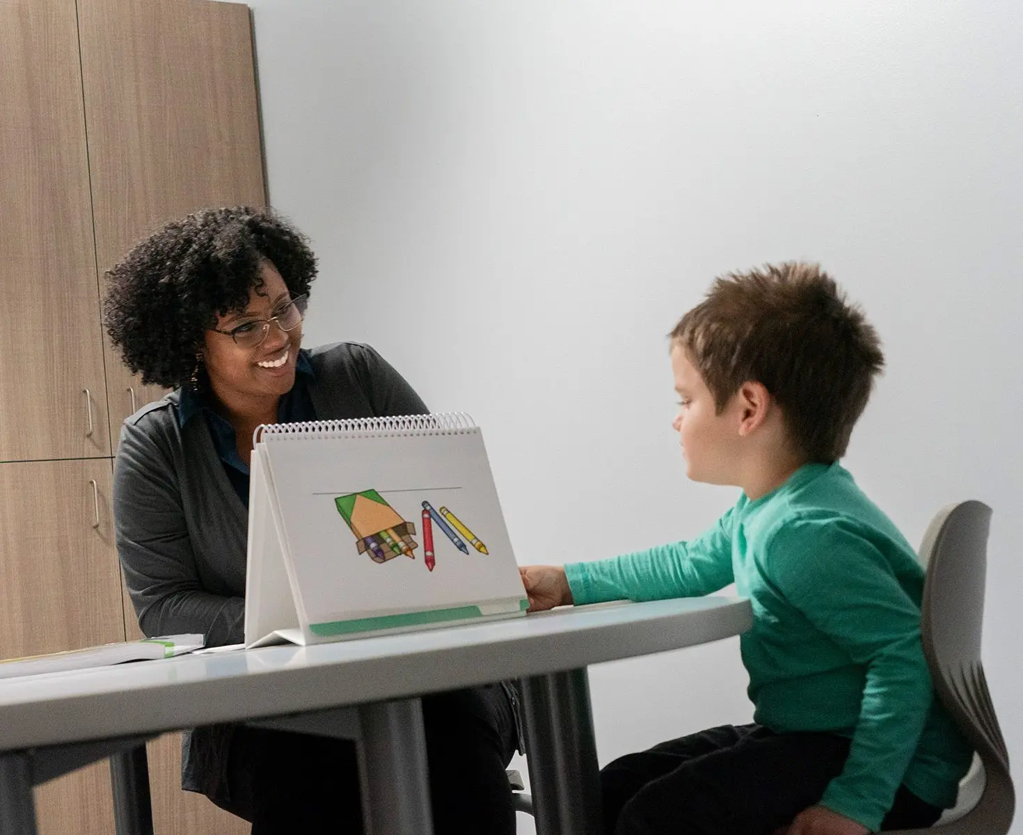 Speech therapist student in Early Childhood Education Program works with a child patient.
