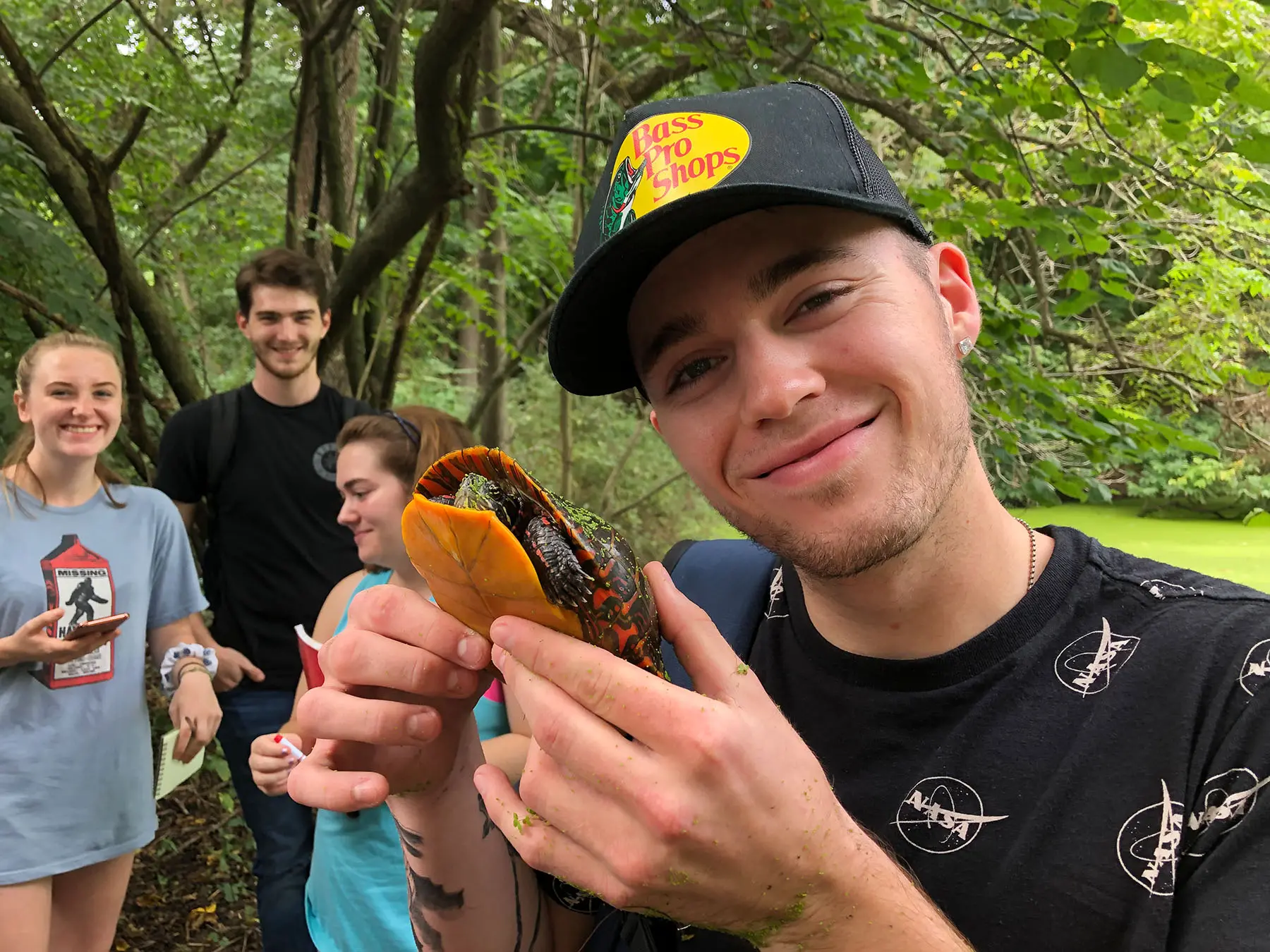 Student holding up specimen