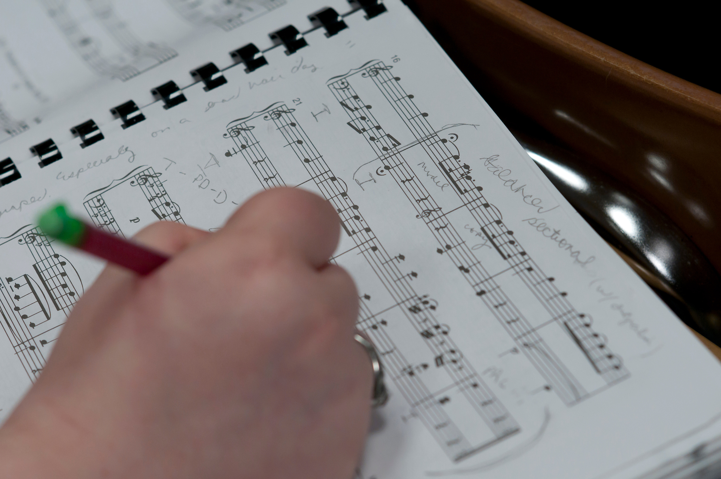 Music major writes notes on sheet music