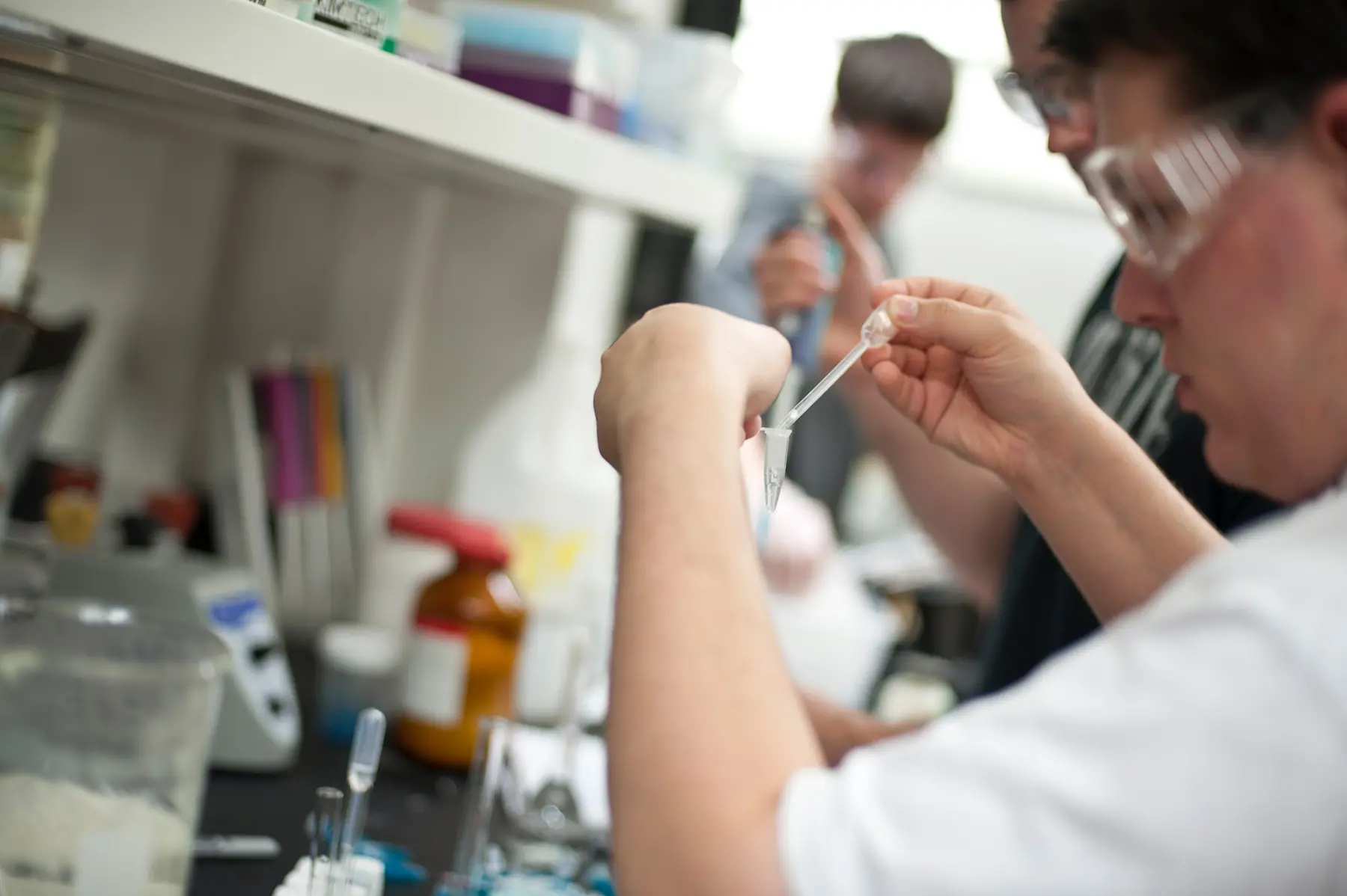 Biochem student working in lab with safety gear