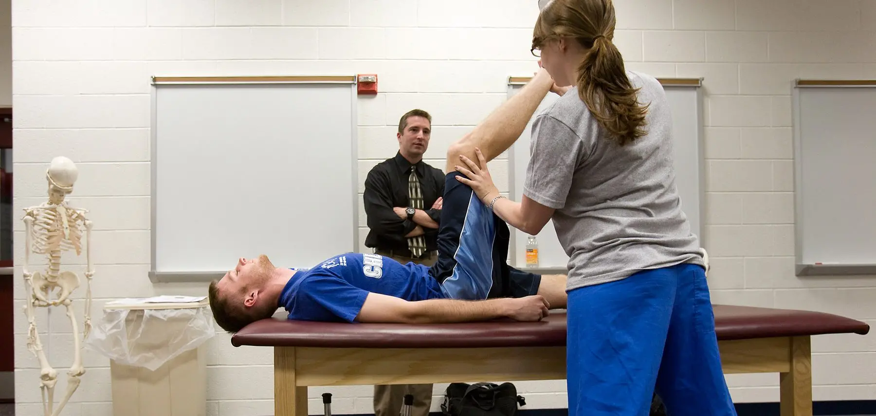 Physical therapist student working with patient.
