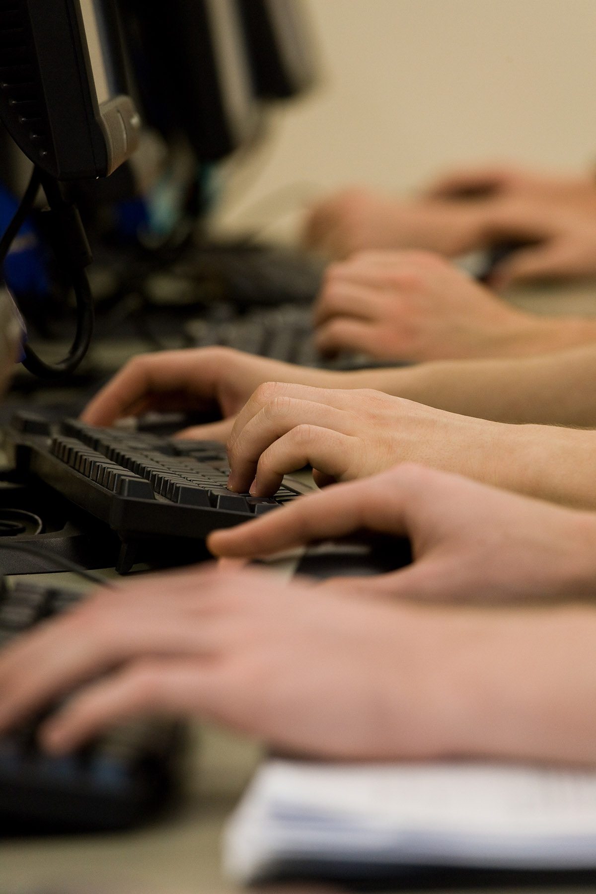 Closeup of students' hands on computer keyboards