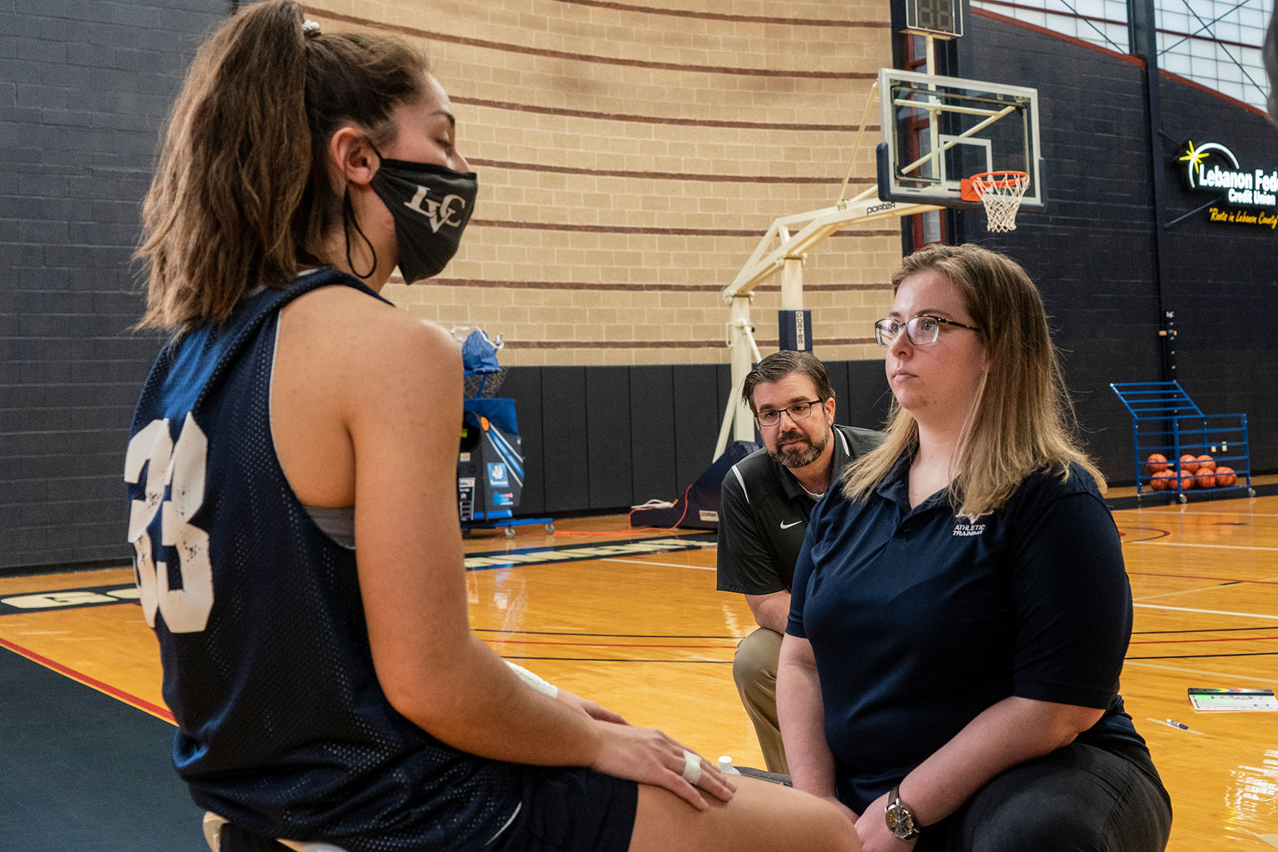 Athletic training students working with basketball player
