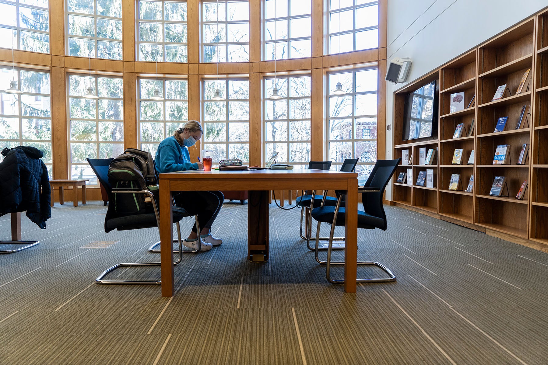 Interior of student studying at large library table