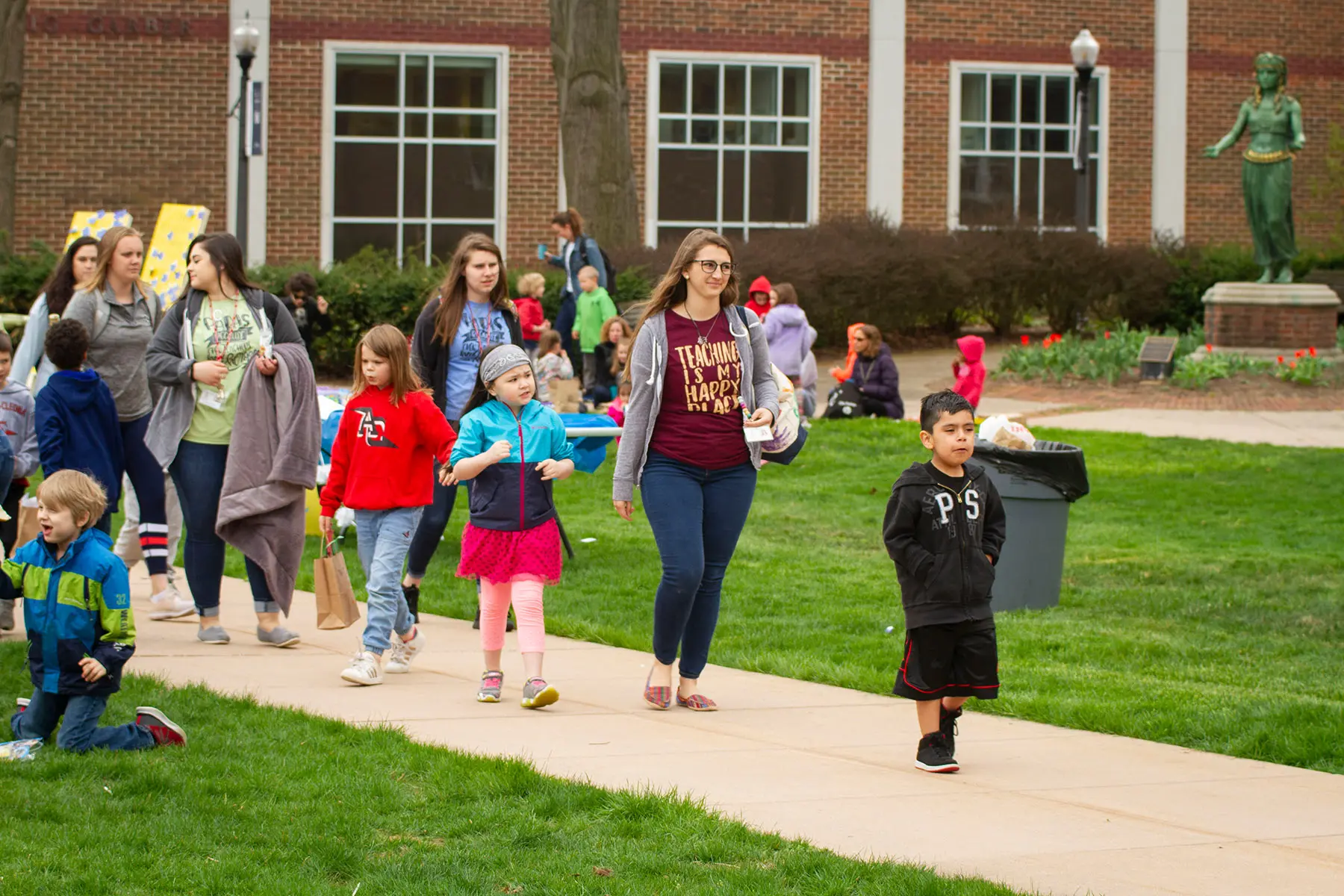 Student educator walking with group of children