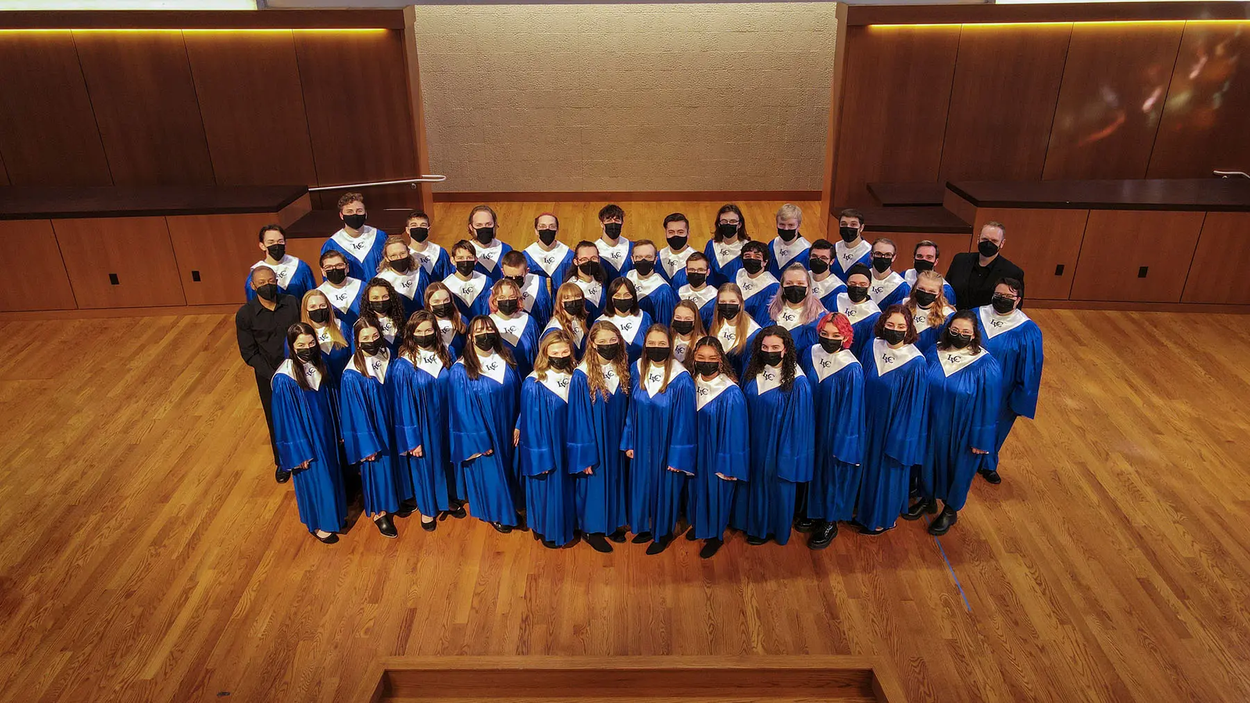 Choir standing in robes on stage