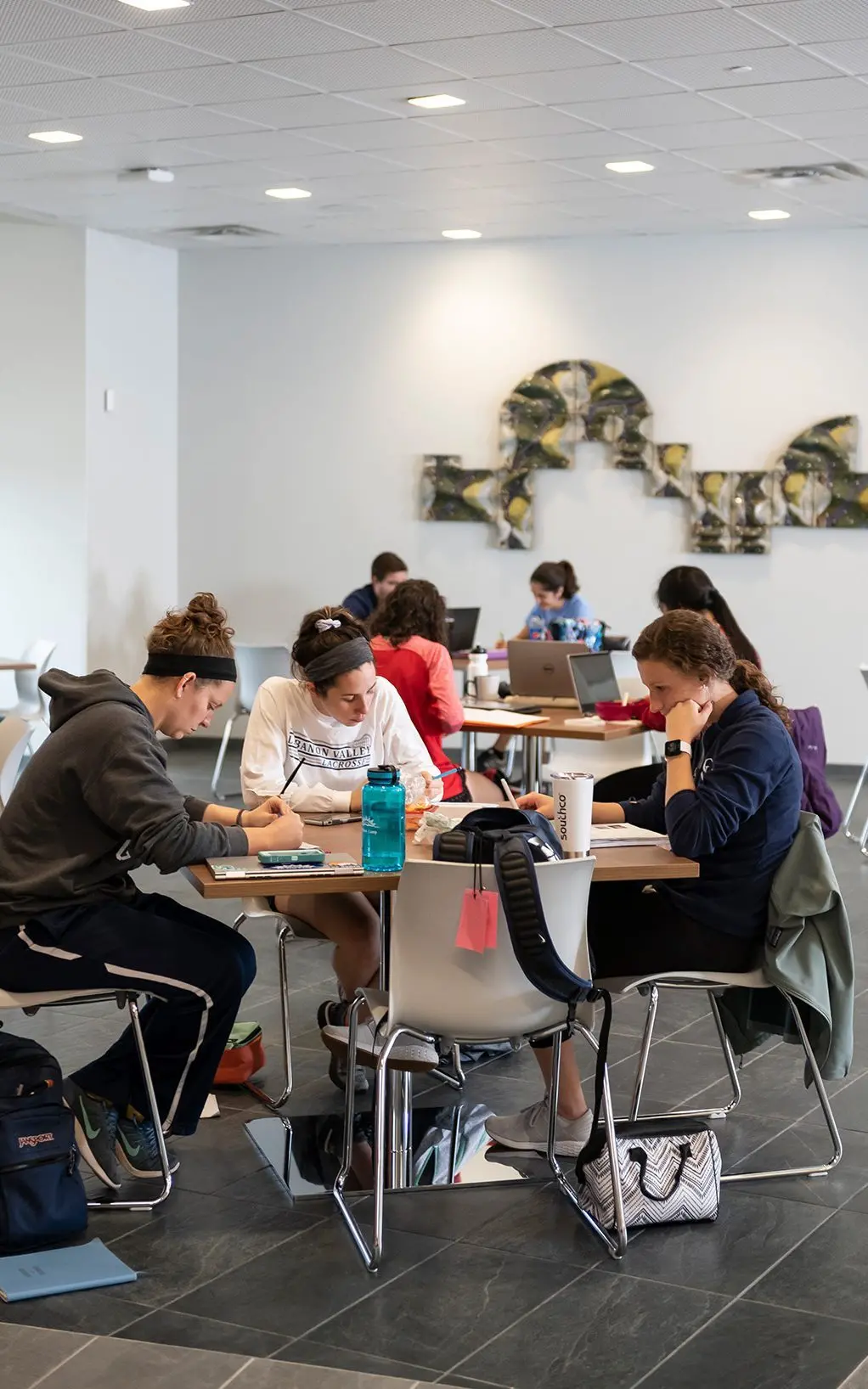 Students sitting at tables studying.