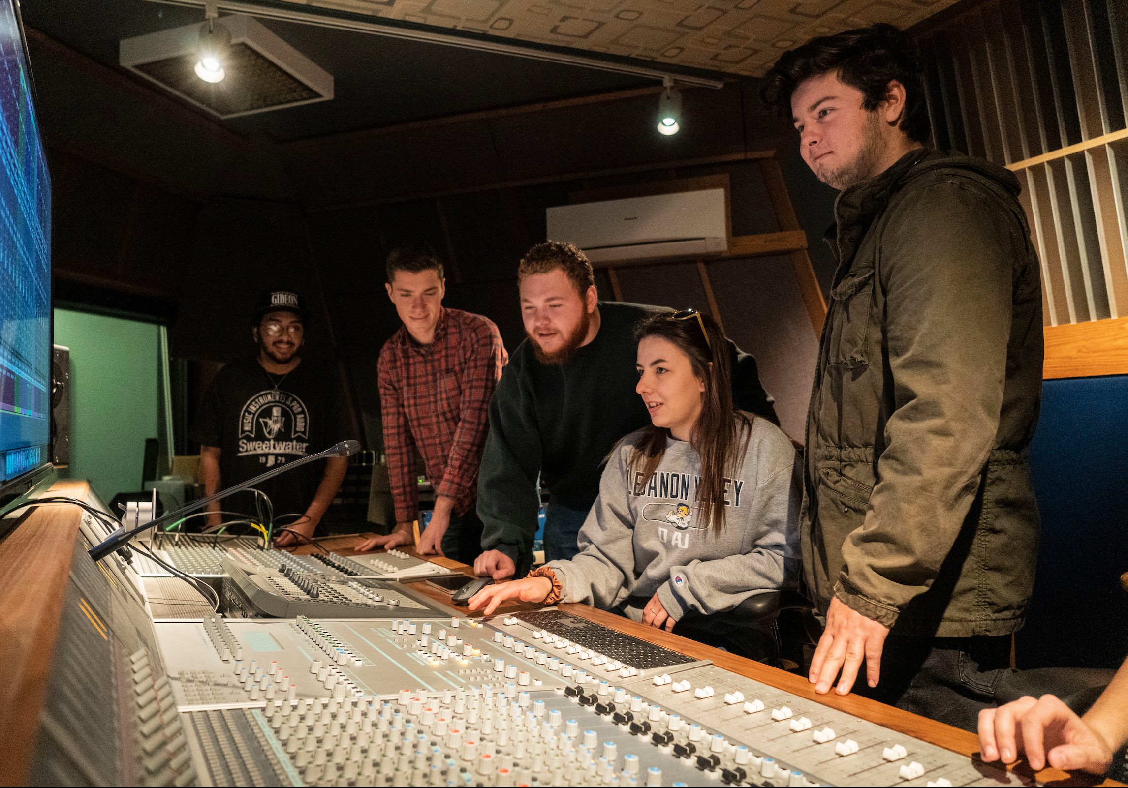 Students work on audio equipment in Studio A