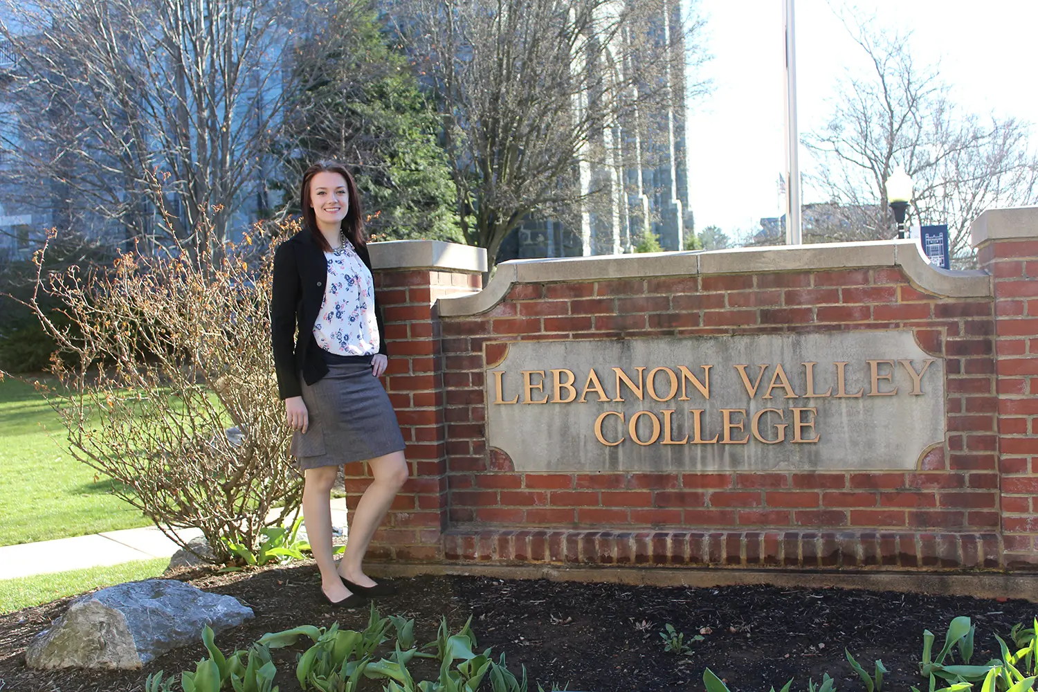 Jasmine Olvany stands next to LVC sign