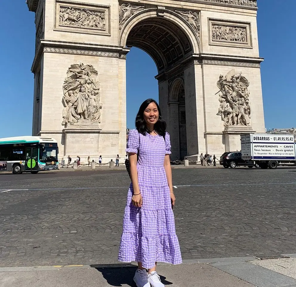 LVC student smiling in front of the Arc De Triomph in Paris
