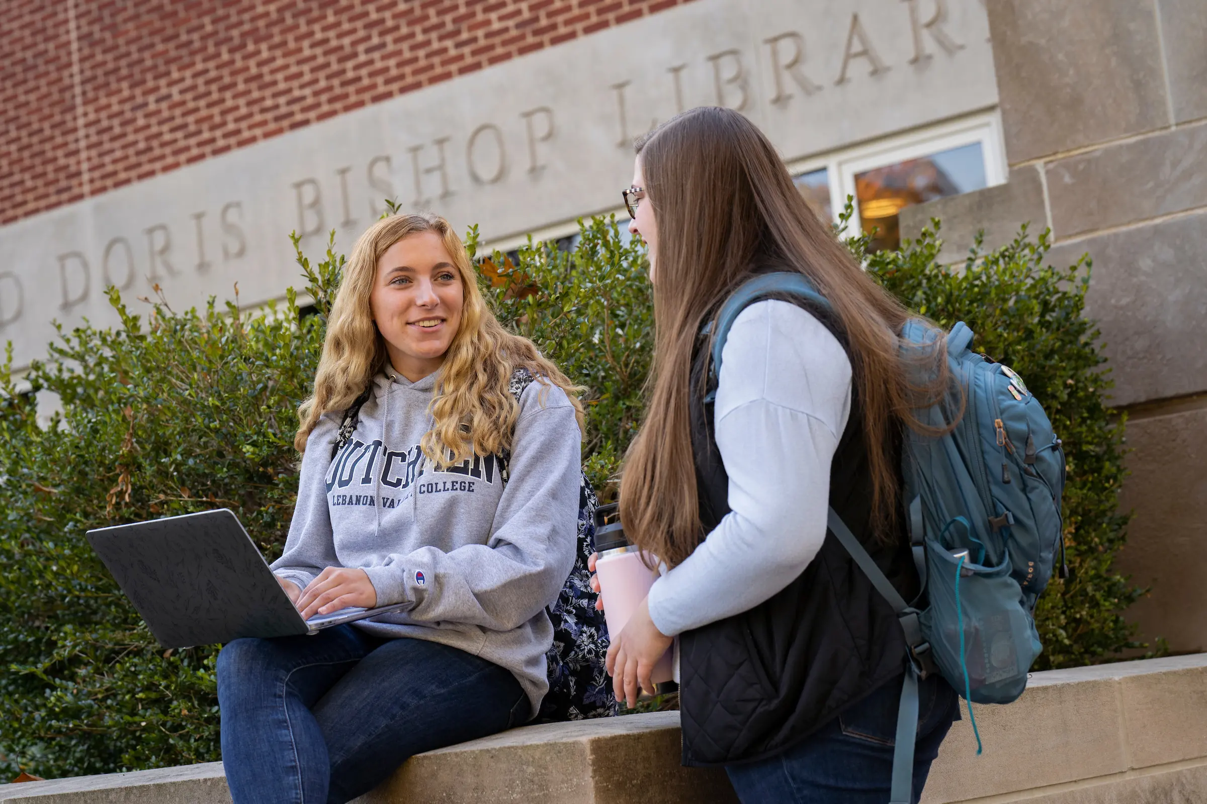 Students talk outside of Bishop Library