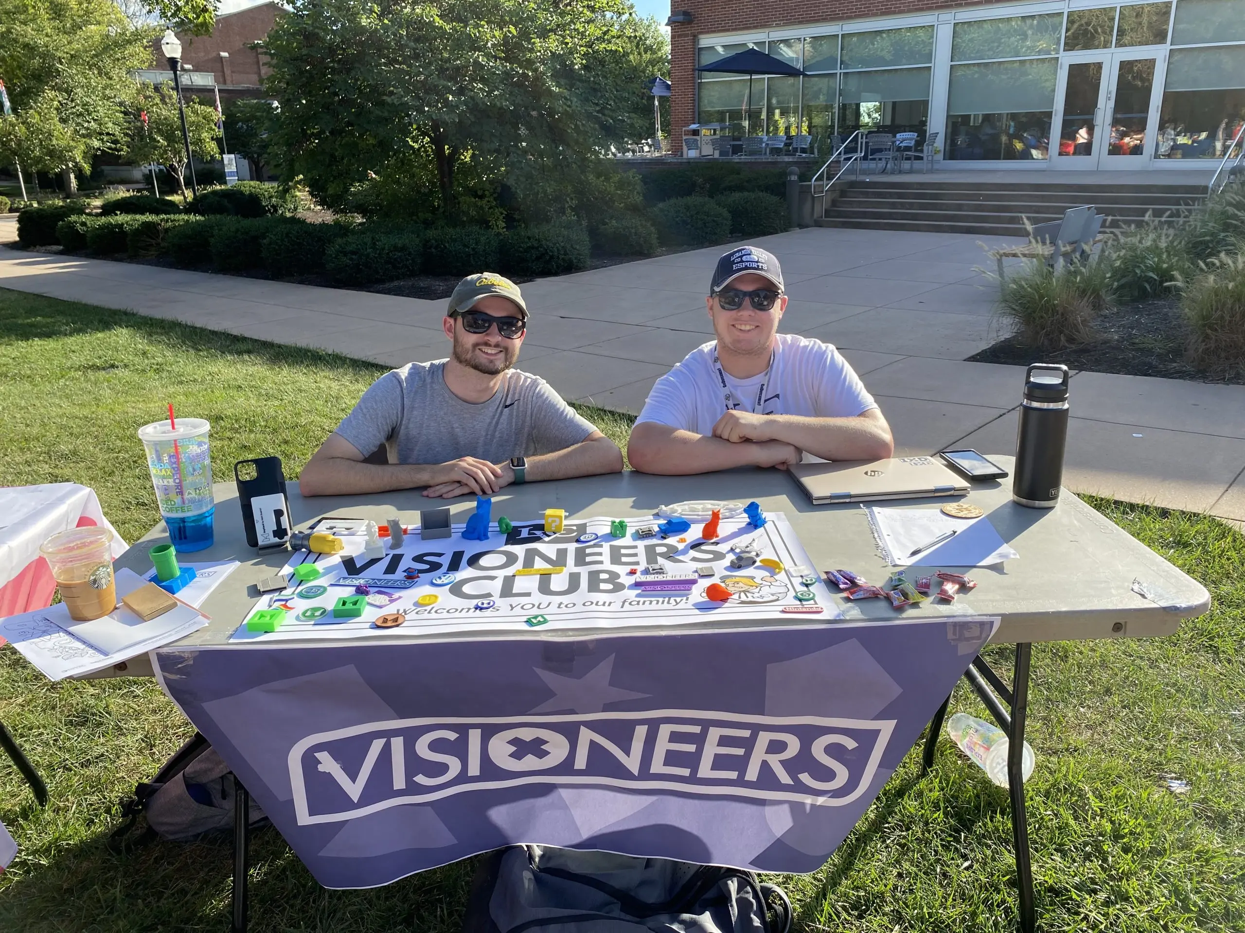 Student members of Visioneers club host table at engagement fair