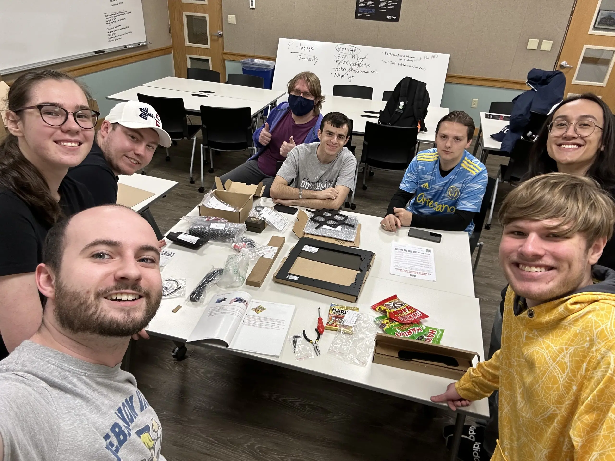 Interaction design students smile around table