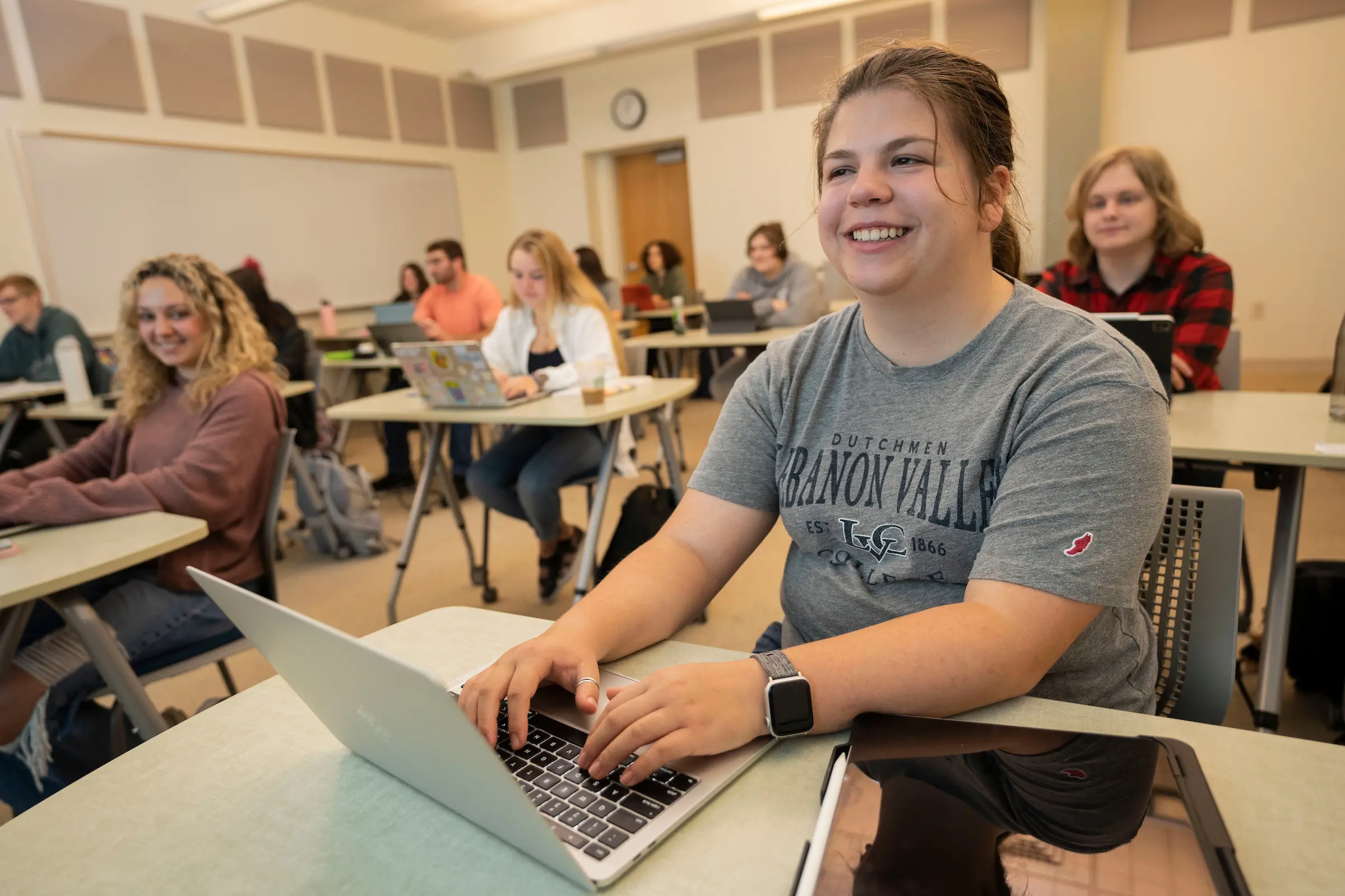 Students sit at desks in class