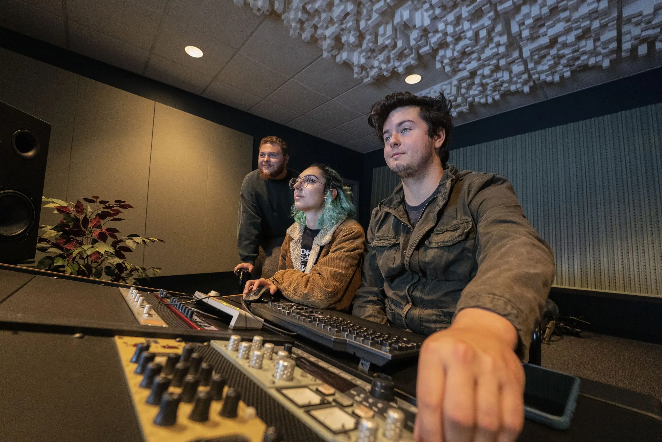 Audio music production students work on studio