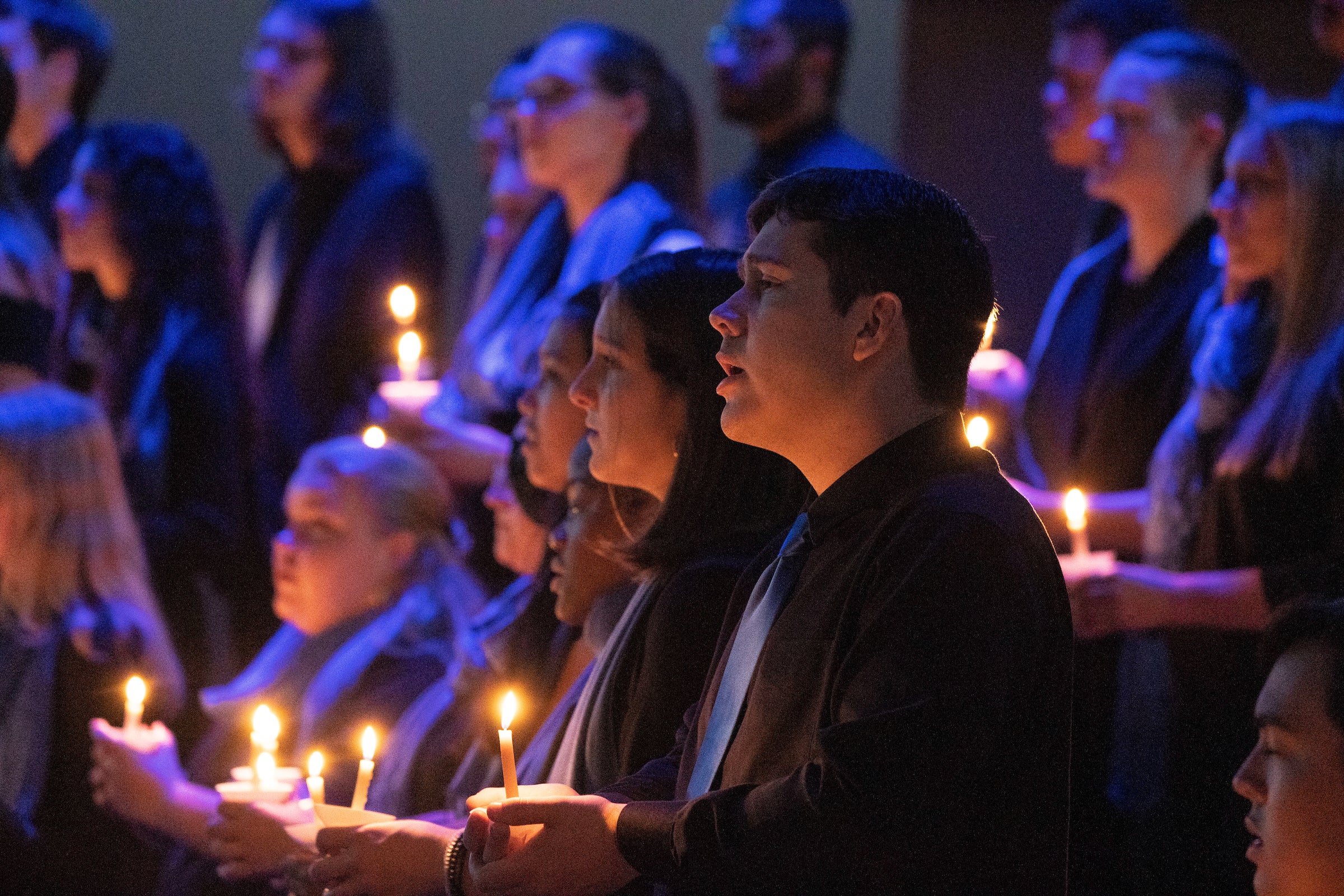 Choir sings while holding candles
