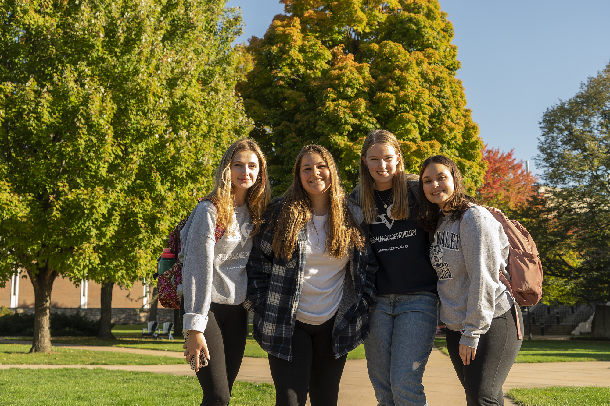 female students pose on the quad